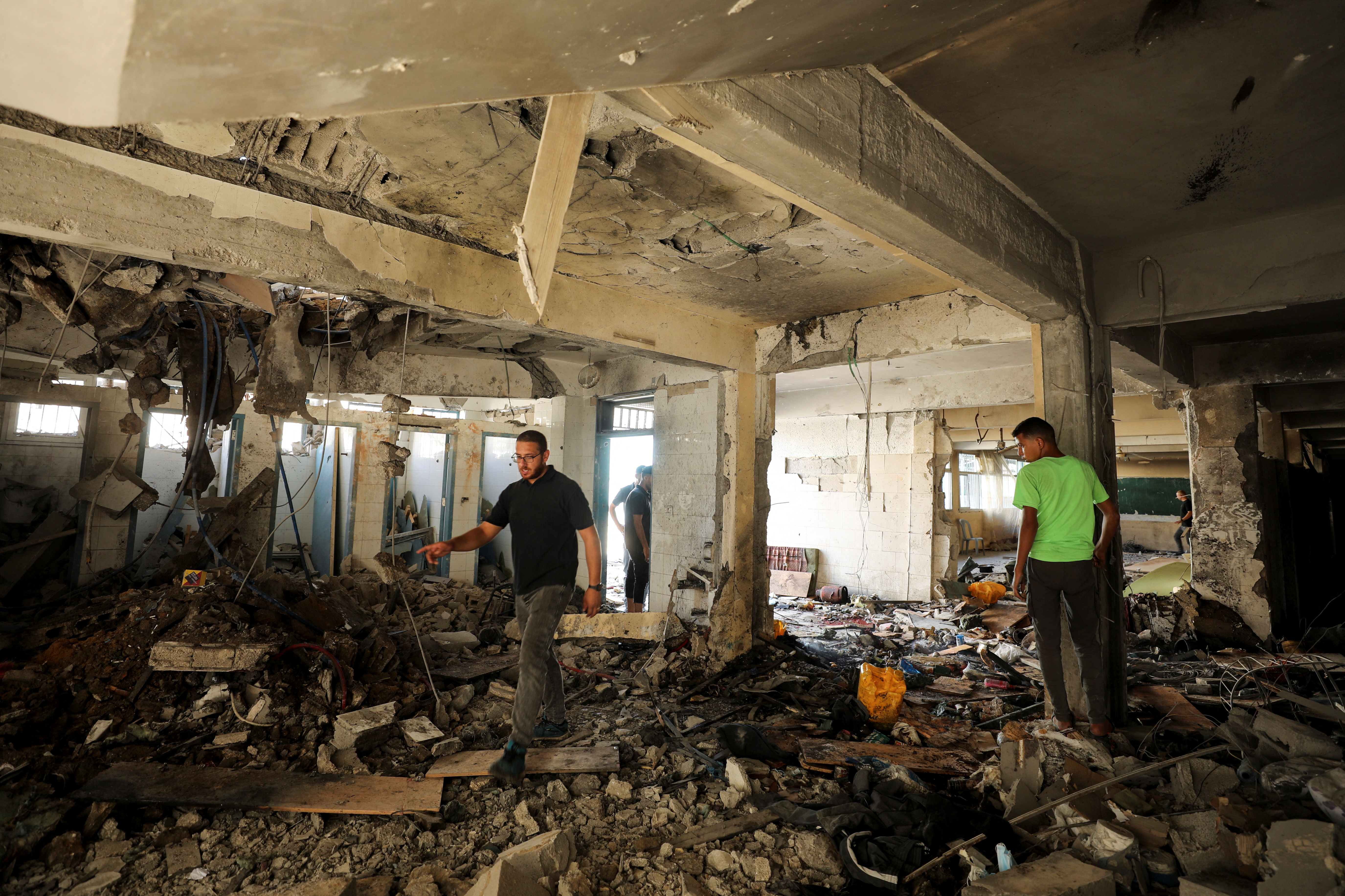 Palestinians inspect a school, which was sheltering displaced people, after it was hit by an Israeli strike, amid the Israel-Hamas conflict, in Gaza City, September 21, 2024. [REUTERS/Dawoud Abu Alkas]