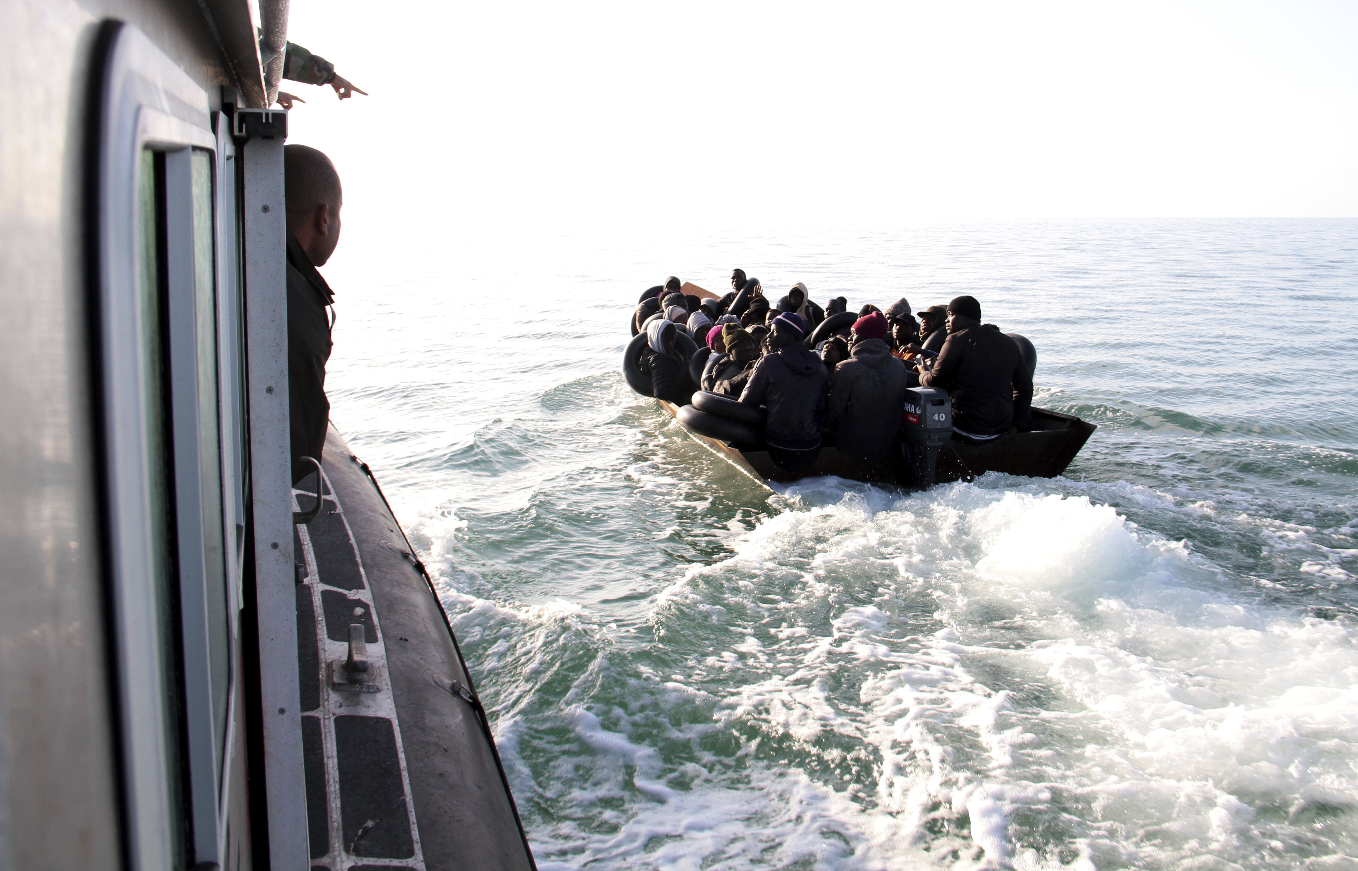 FILE - Migrants, mainly from sub-Saharan Africa, are stopped by the Tunisian Maritime National Guard at sea during an attempt to get to Italy, near the coast of Sfax, Tunisia, on April 18, 2023. Tens of thousands of migrants are trapped in an increasingly violent limbo in camps In Tunisia, blocked from reaching Europe but too poor to go home, and facing backlash from local residents. (AP Photo, File)
