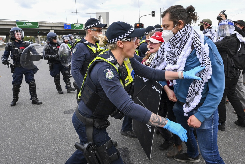 Victoria Police clash with anti-war protesters outside a military arms convention in downtown Melbourne