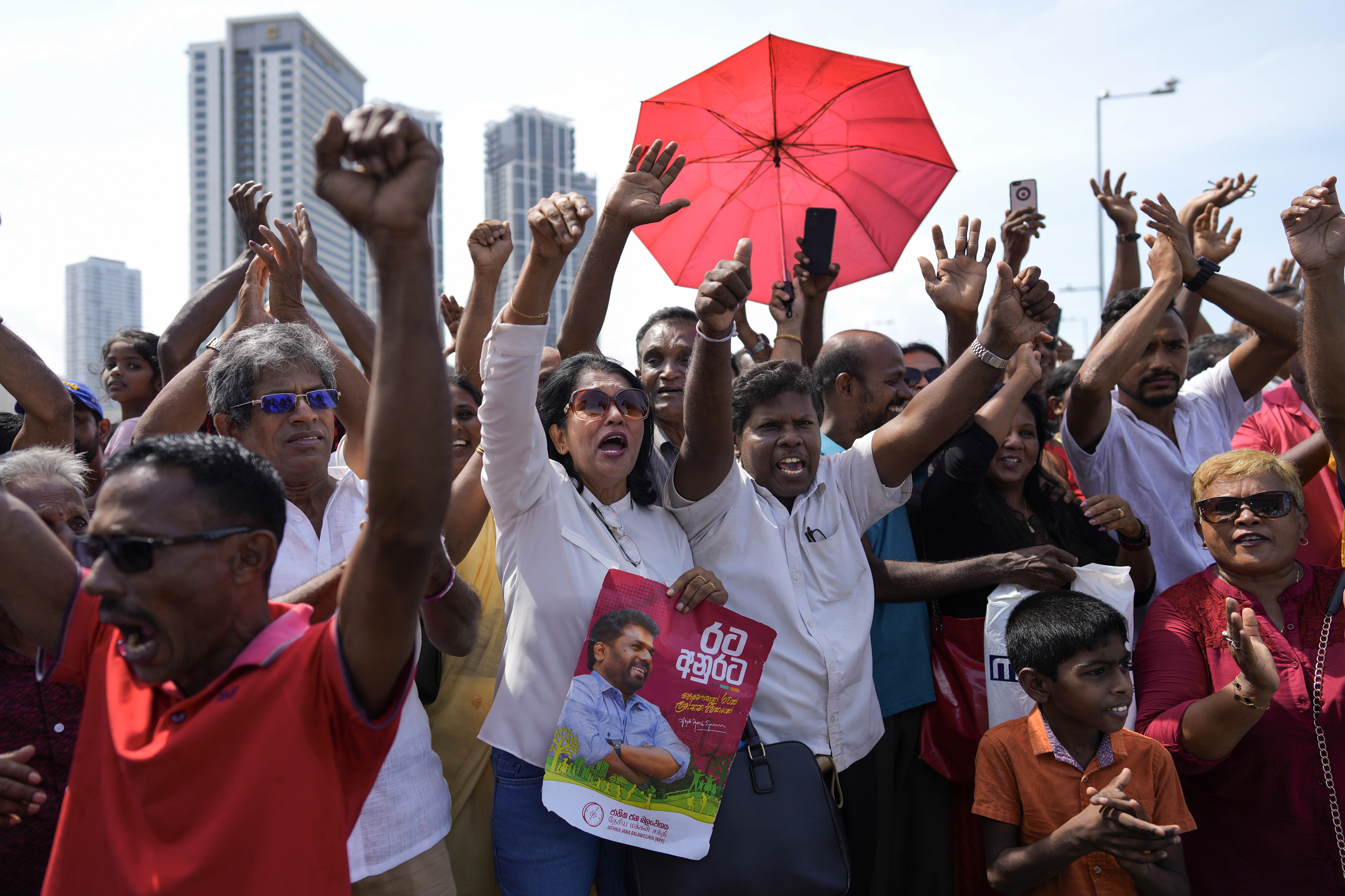 Supporters of Marxist-leaning Anura Kumara Dissanayake cheer outside the president&#039;s office as he arrives to be sworn in as Sri Lanka&rsquo;s president in Colombo [File: Eranga Jayawardena/AP Photo]