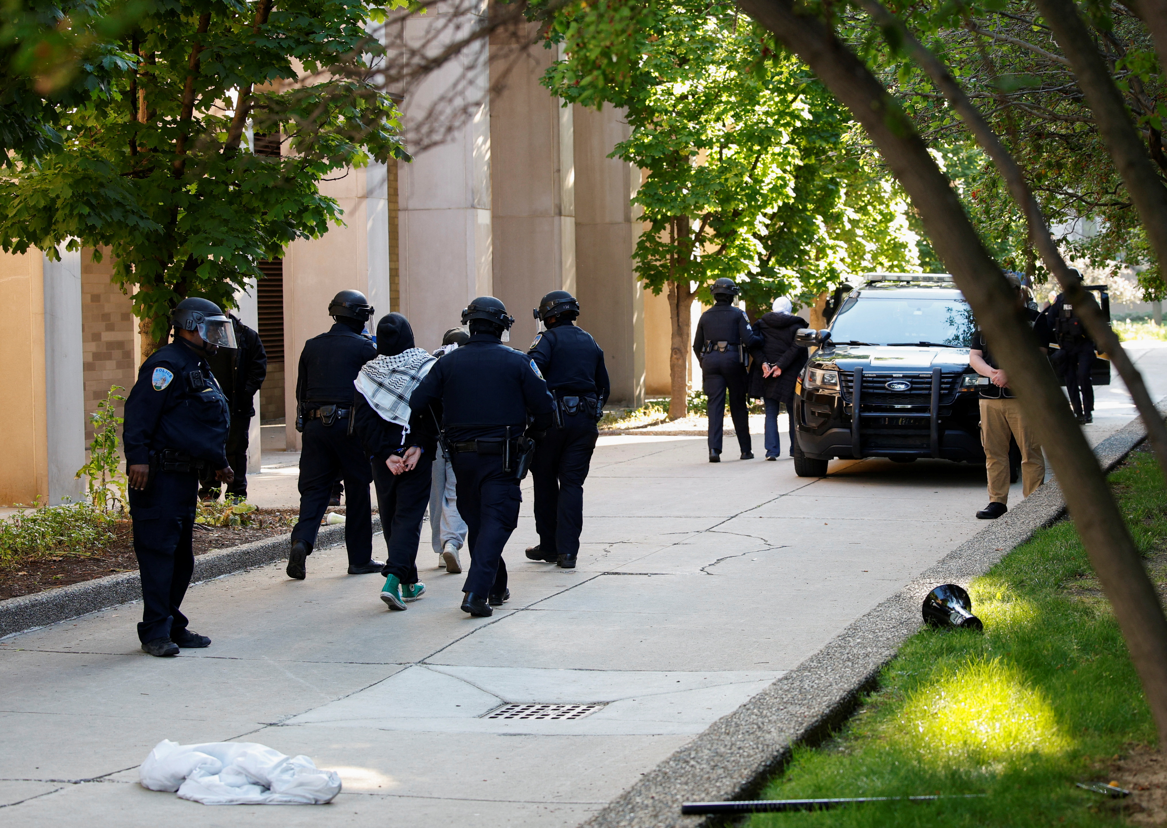 Three female pro-Palestinian protestors are detained by Wayne State University police after they protested the police raid of the campus encampment in Detroit, Michigan, U.S., May 30, 2024. REUTERS/Rebecca Cook