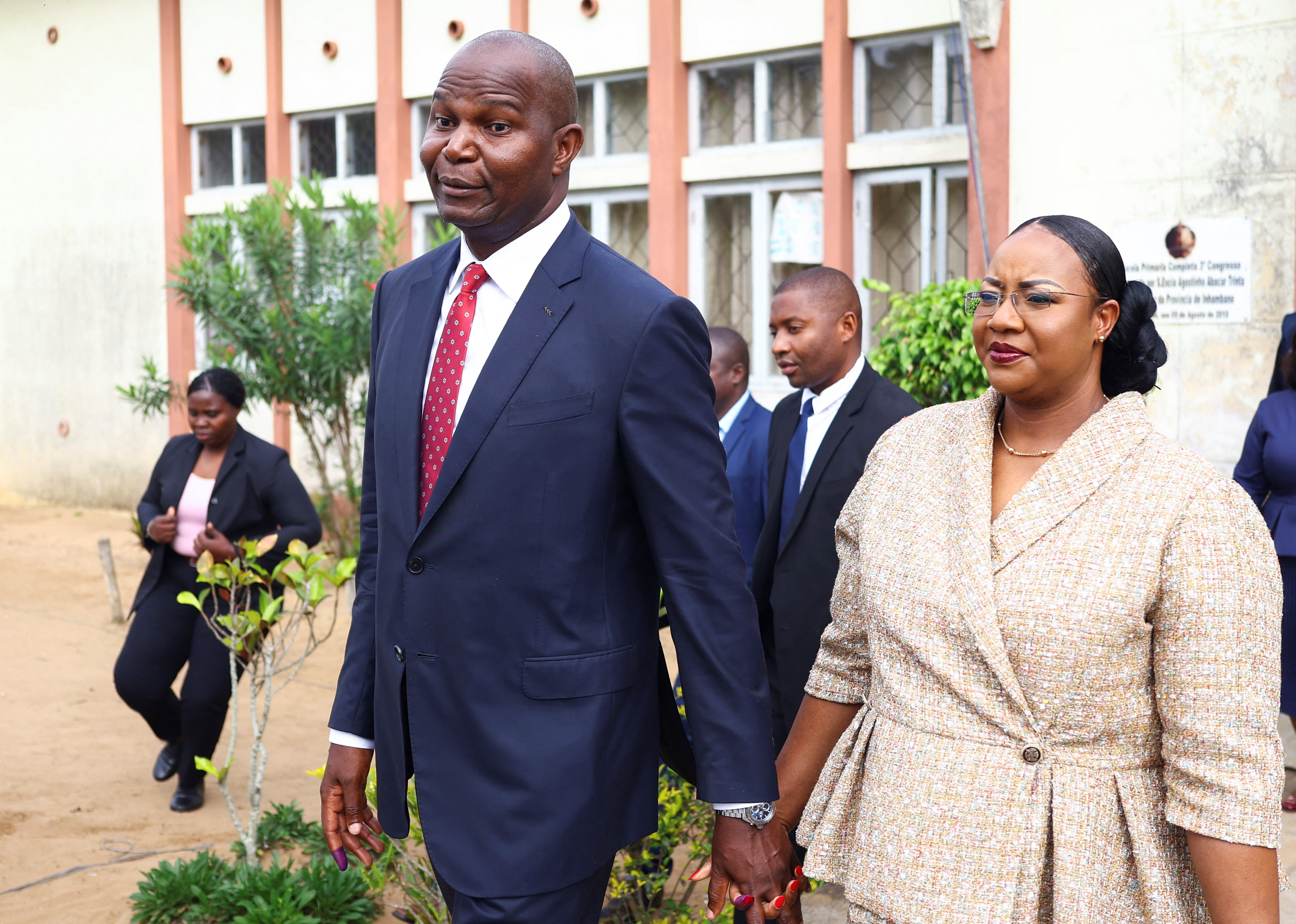 Daniel Chapo, presidential candidate of the ruling Frelimo party leaves with his wife, Gueta Chapo after casting their vote during the general elections at Inhambane, in southern Mozambique