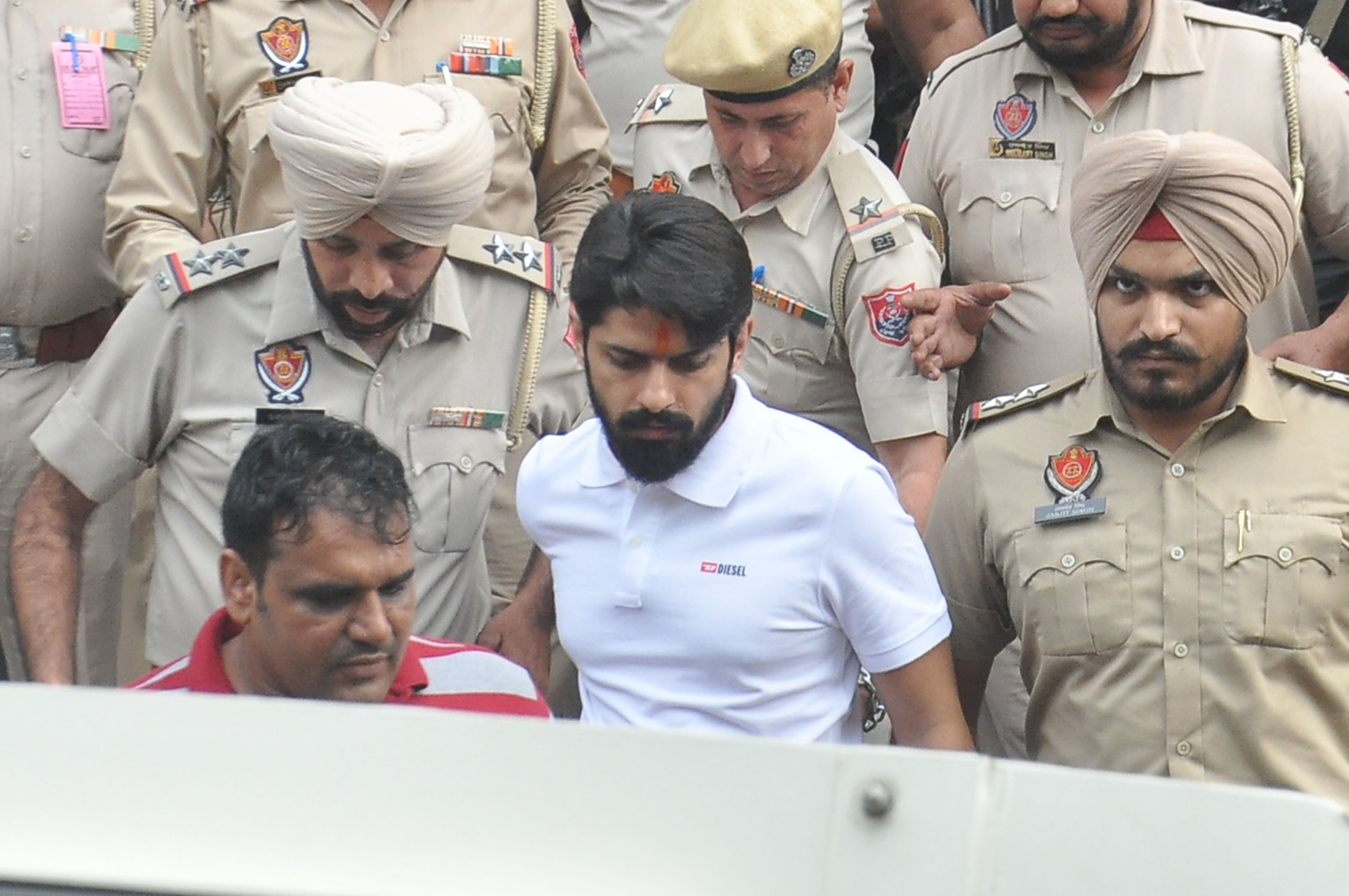 Lawrence Bishnoi amid heavy police security while coming out of a court.