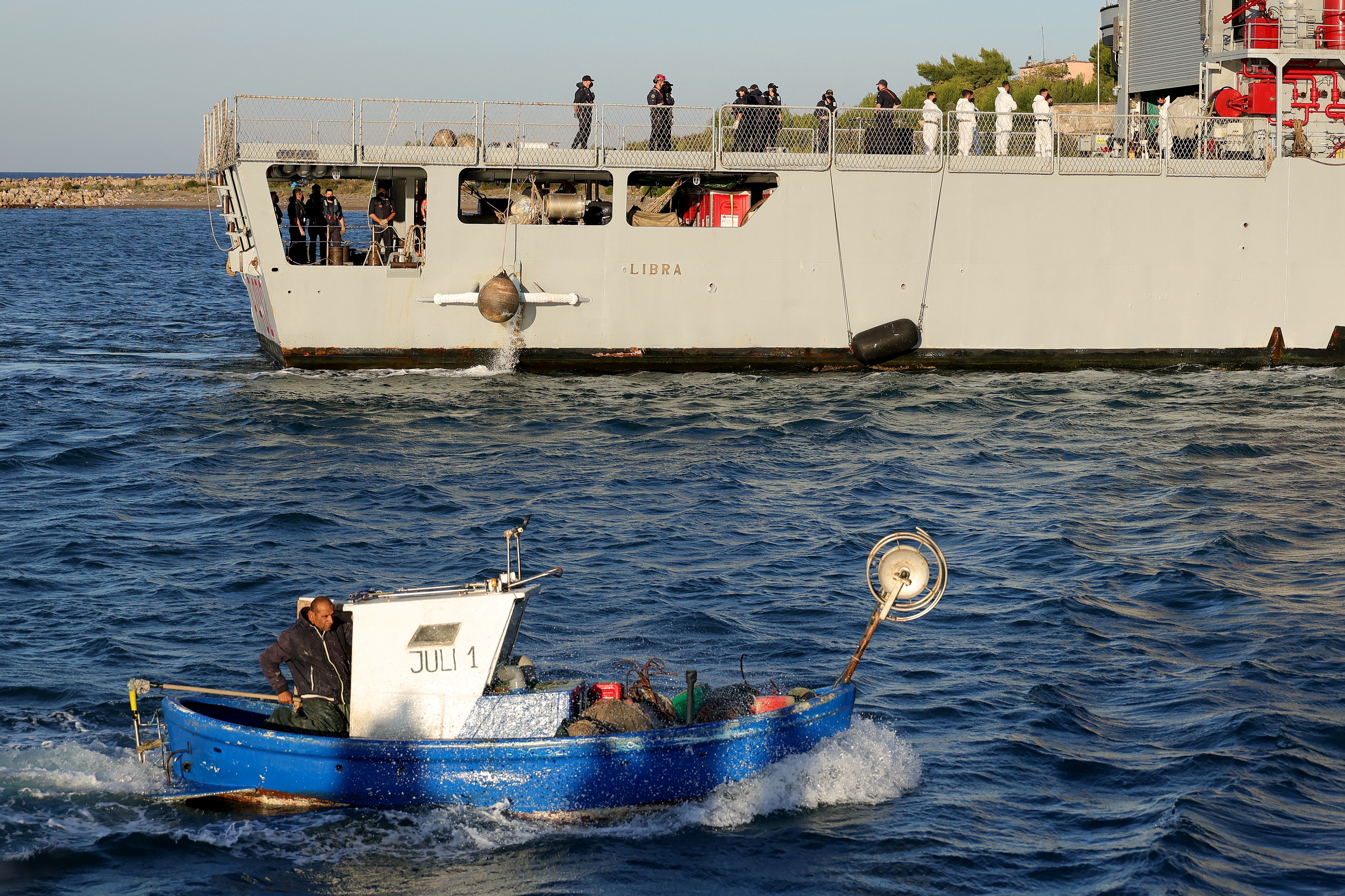 A navy boat carrying migrants intercepted in Italian waters docked at Shengjin port in Albania on October 16 [Adnan Beci / AFP]