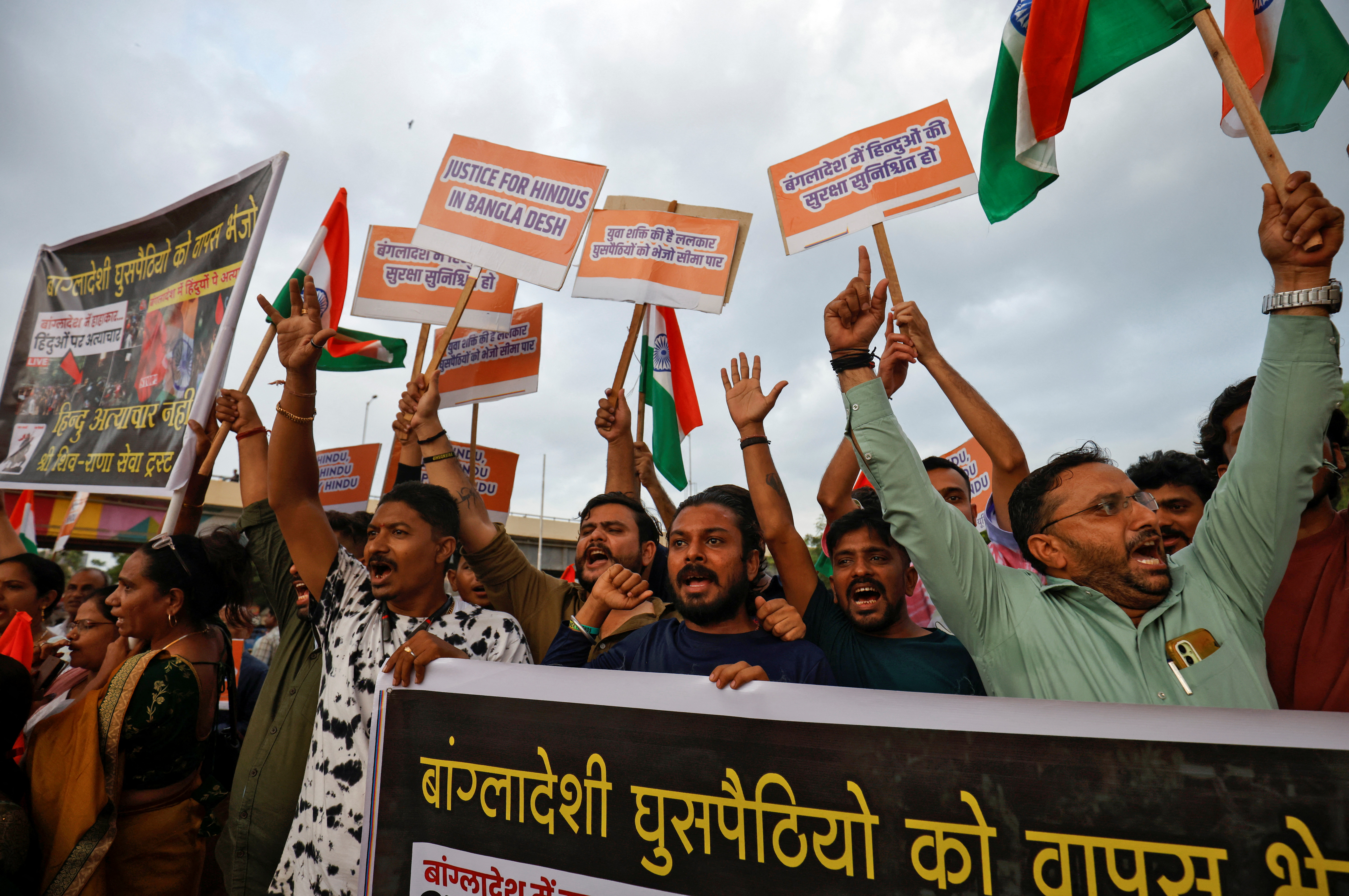 Hindu activists hold placards and Indian national flags, chant the slogan, "Stop atrocities on Hindus", and protest attacks on religious places of Hindus in Bangladesh, in Ahmedabad, India August 13, 2024. REUTERS/Amit Dave