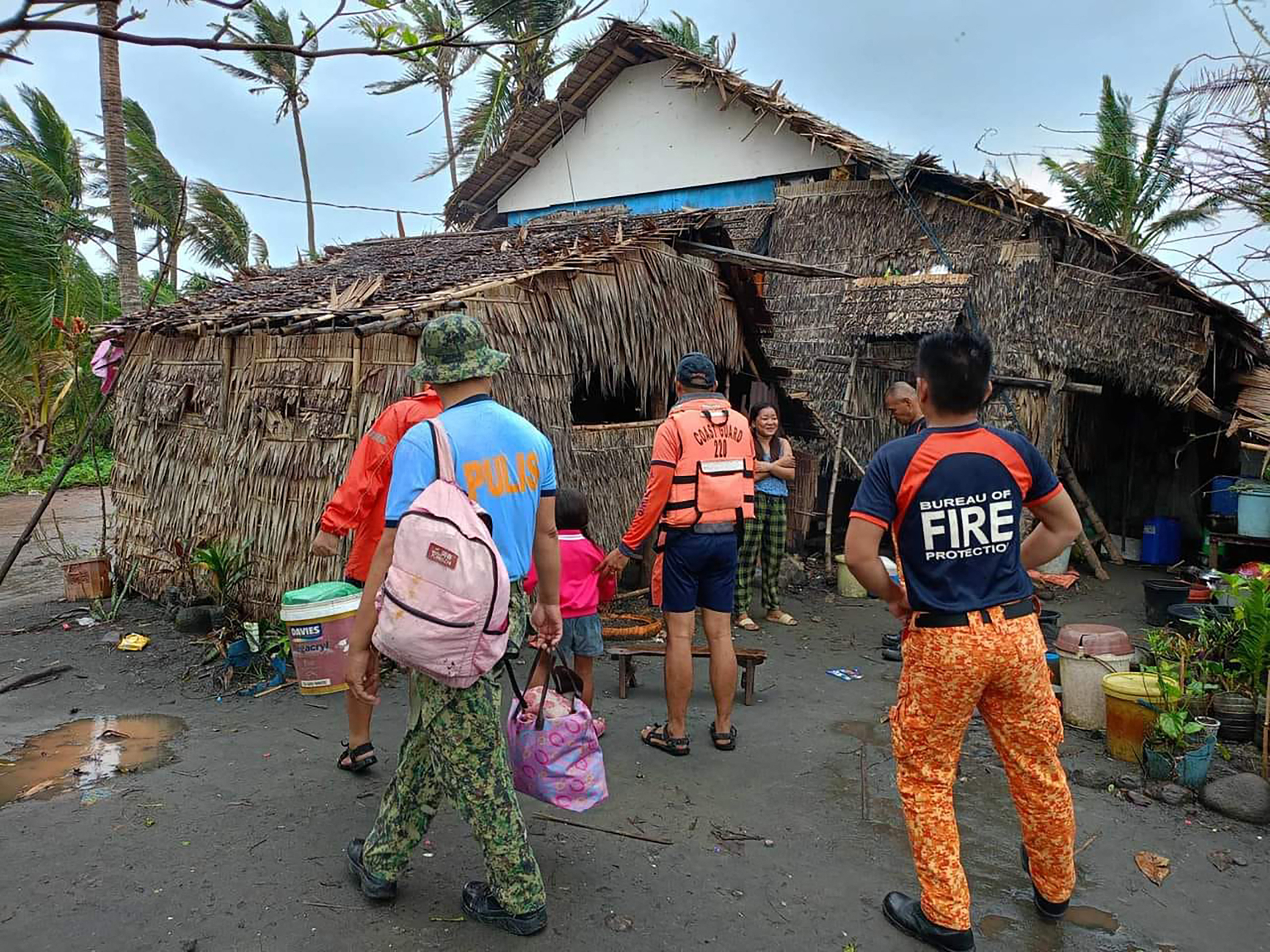 This handout photo taken on November 14, 2024 and released by Buguey Municipal Disaster Risk and Reduction Management Office via Cagayan Provincial Public Information office shows rescuers fetching residents during a forced evacuation operation in Buguey town, Cagayan province, north of Manila, ahead of Super Typhoon Usagi's landfall. The Philippines raised its highest storm alert and evacuated thousands of people on November 14, as Super Typhoon Usagi barrelled towards its already disaster-ravaged north. (Photo by Handout / BUGUEY MUNICIPAL DISASTER RISK AND REDUCTION MANAGEMENT OFFICE VIA CAGAYAN PROVINCIAL PUBLIC INFORMATION OFFICE / AFP) / - NO EDITORIAL USE - NO MARKETING CAMPAIGN / -----EDITORS NOTE --- RESTRICTED TO EDITORIAL USE - MANDATORY CREDIT "AFP PHOTO / BUGUEY MUNICIPAL DISASTER RISK AND REDUCTION MANAGEMENT OFFICE VIA CAGAYAN PROVINCIAL PUBLIC INFORMATION OFFICE " - NO MARKETING - NO ADVERTISING CAMPAIGNS - DISTRIBUTED AS A SERVICE TO CLIENTS