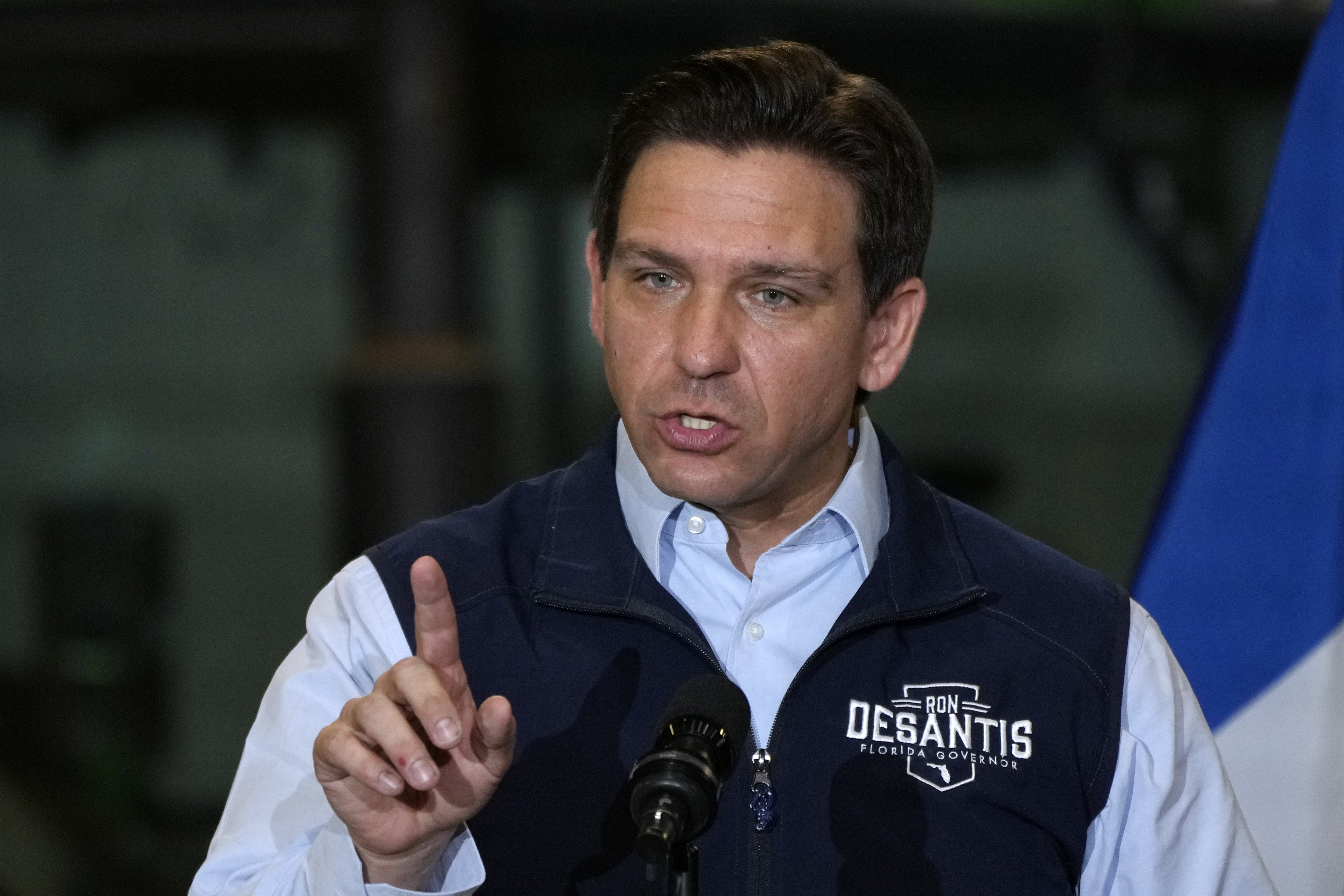 Ron DeSantis, wearing a vest with his name stitched on it.