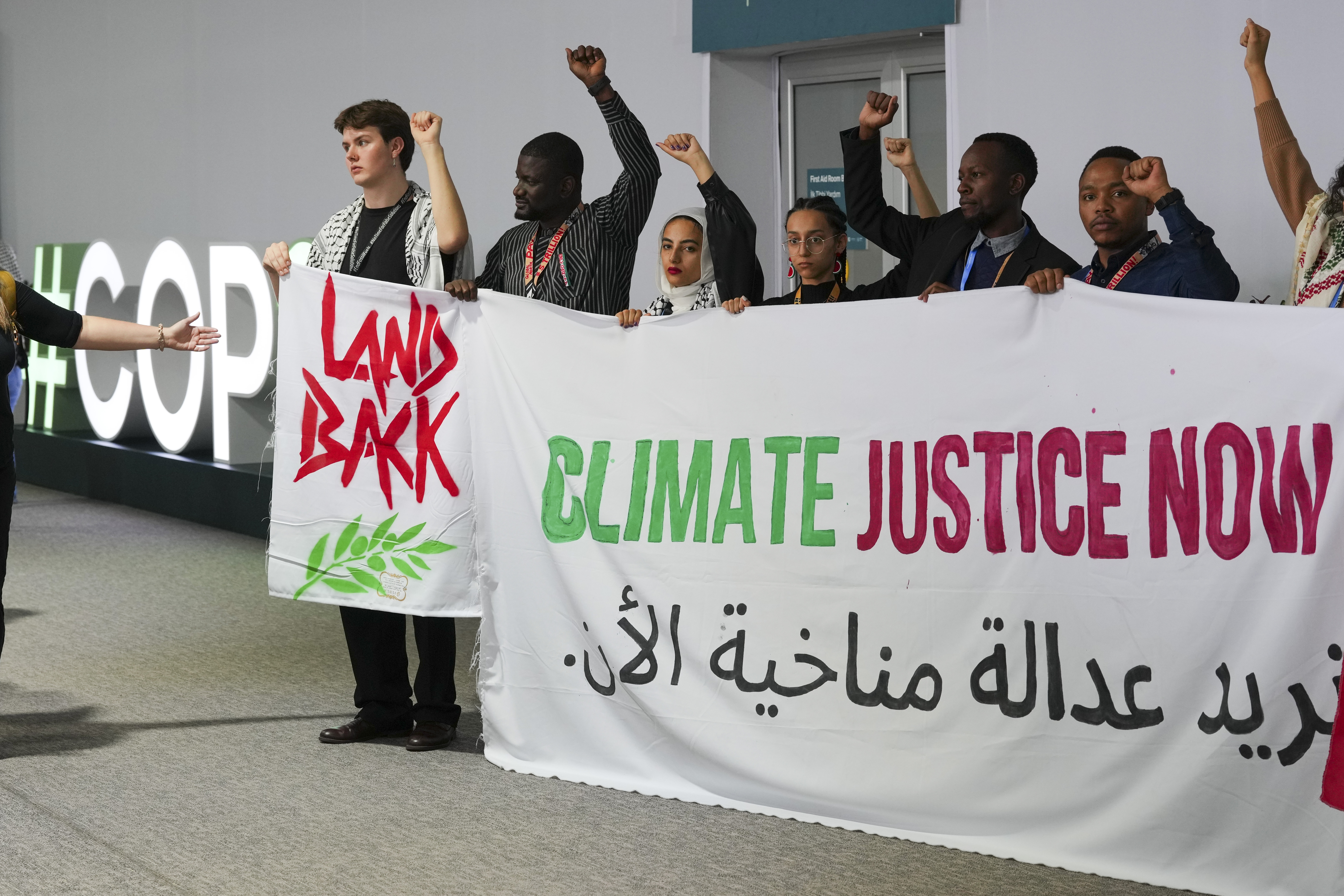 Activists demonstrate for climate justice and a ceasefire in Gaza at the COP29 UN Climate Summit on Monday in Baku, Azerbaijan. [Peter Dejong/AP Photo]