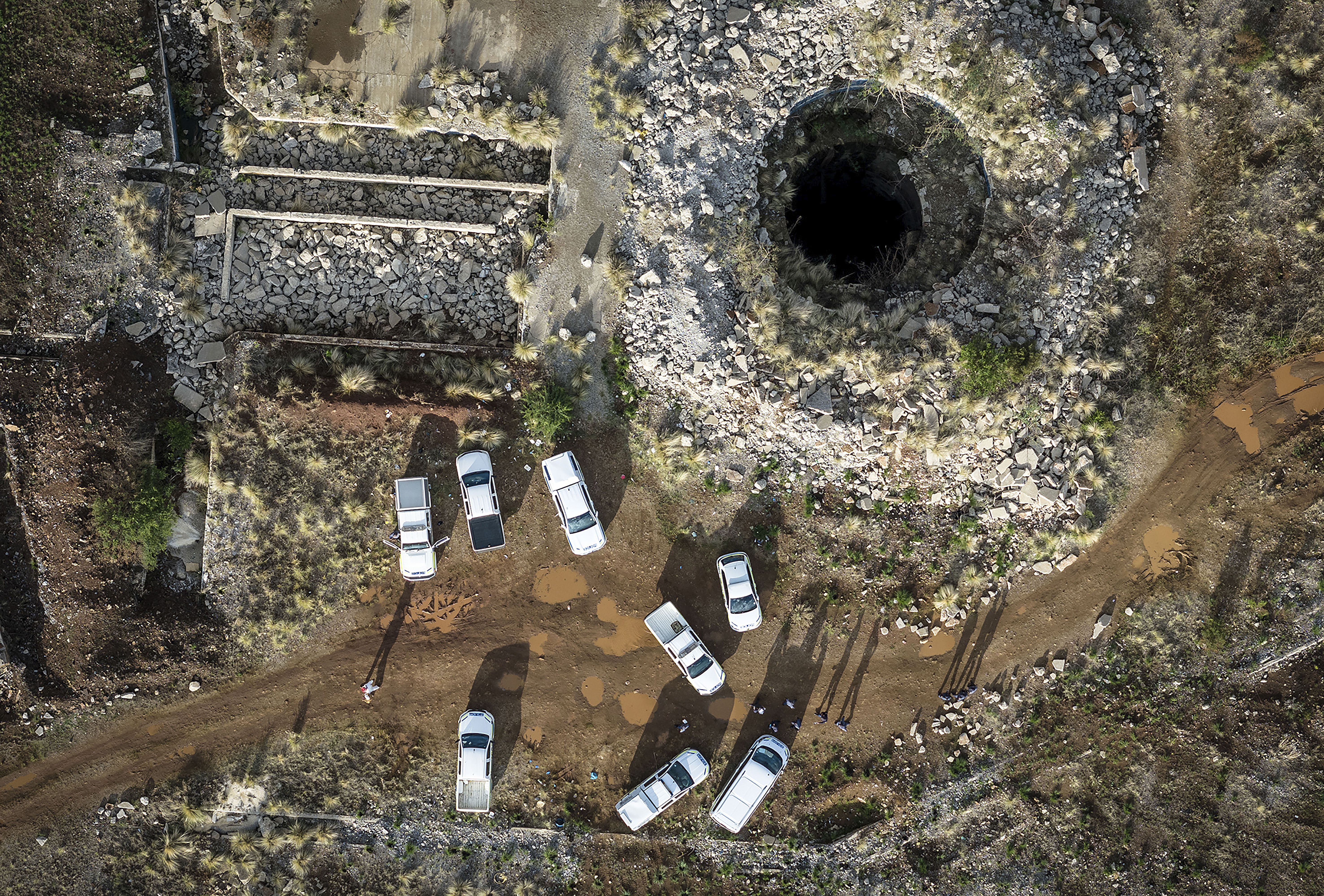 An aerial view of a mine shaft where an estimated 4000 illegal miners are trapped in a disused mine in Stilfontein, South Africa [File:AP Photo]