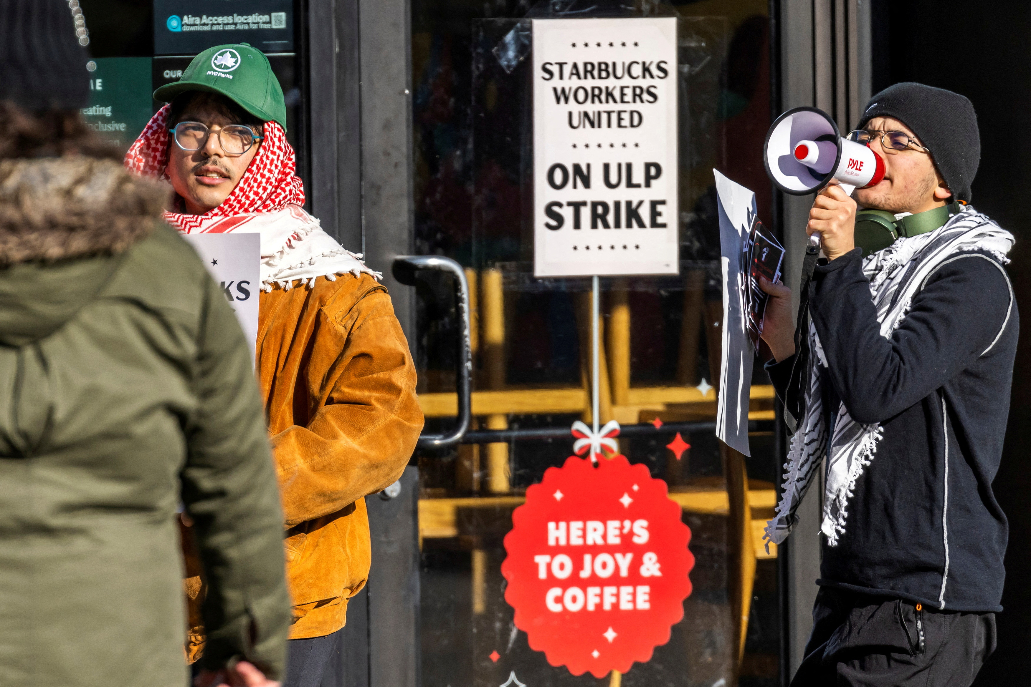 Workers picket in front of a Starbucks