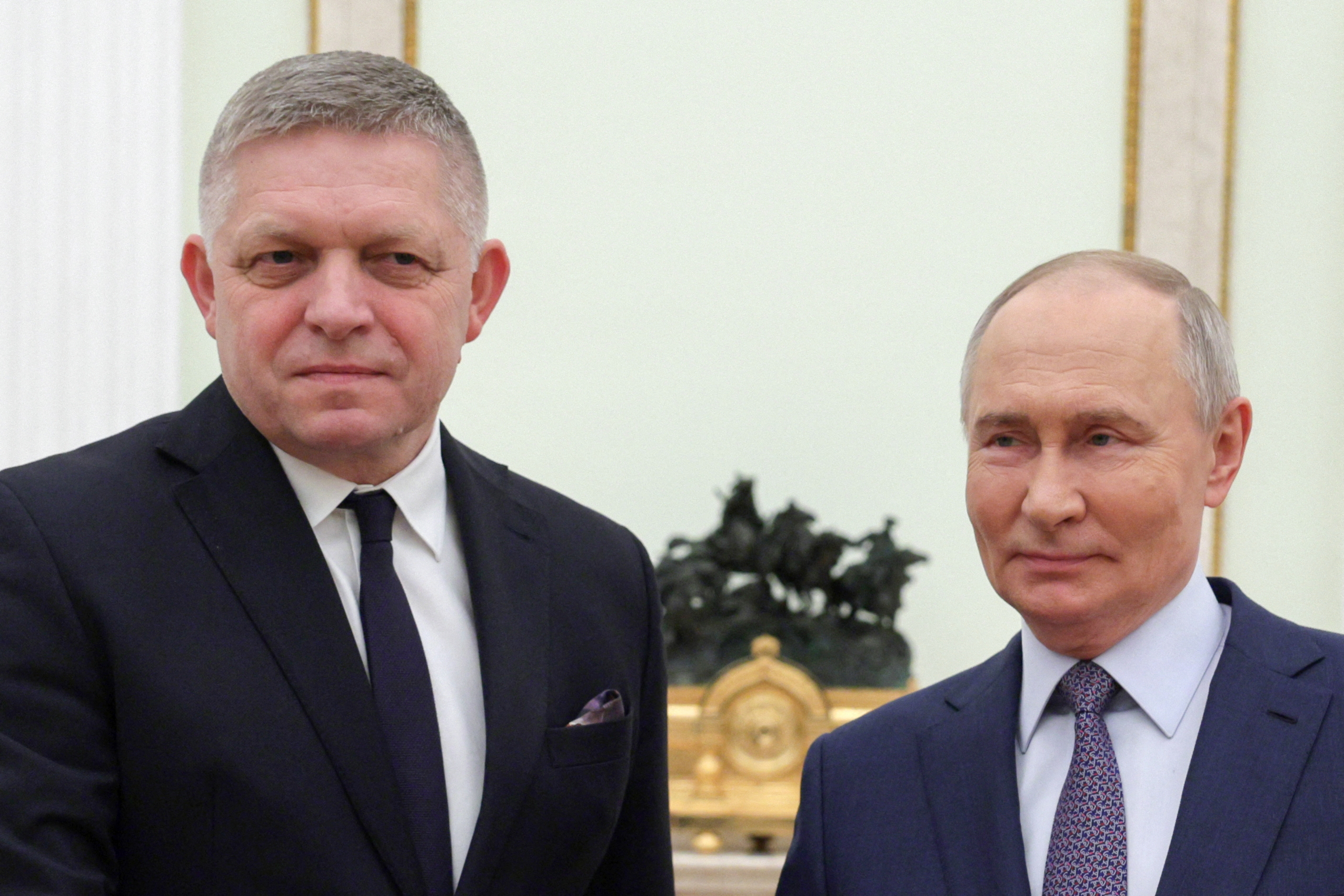 Russia's President Vladimir Putin (R) and Slovakia's Prime Minister Robert Fico (L) pose for a photo