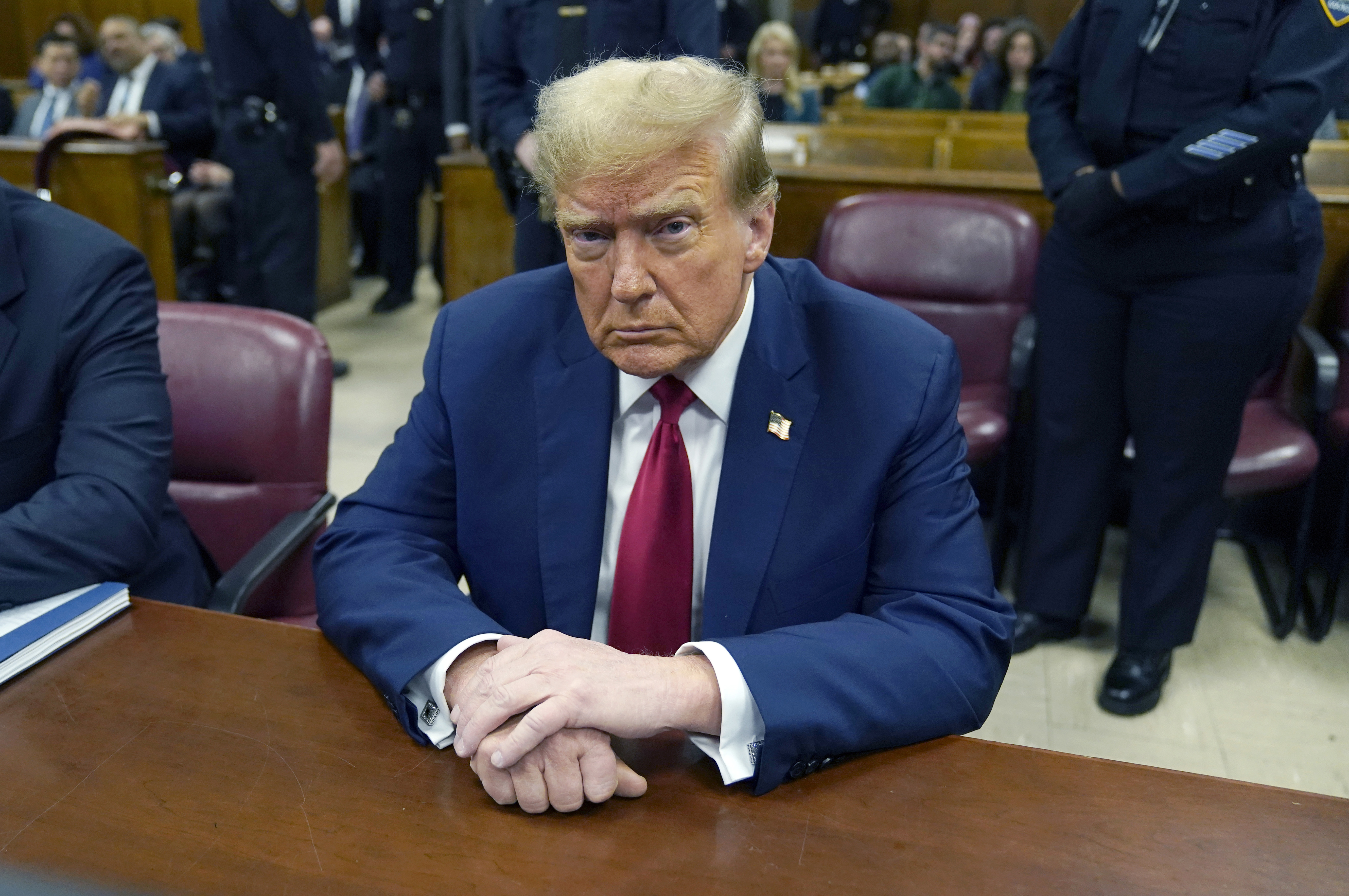 Trump sits in a court room.