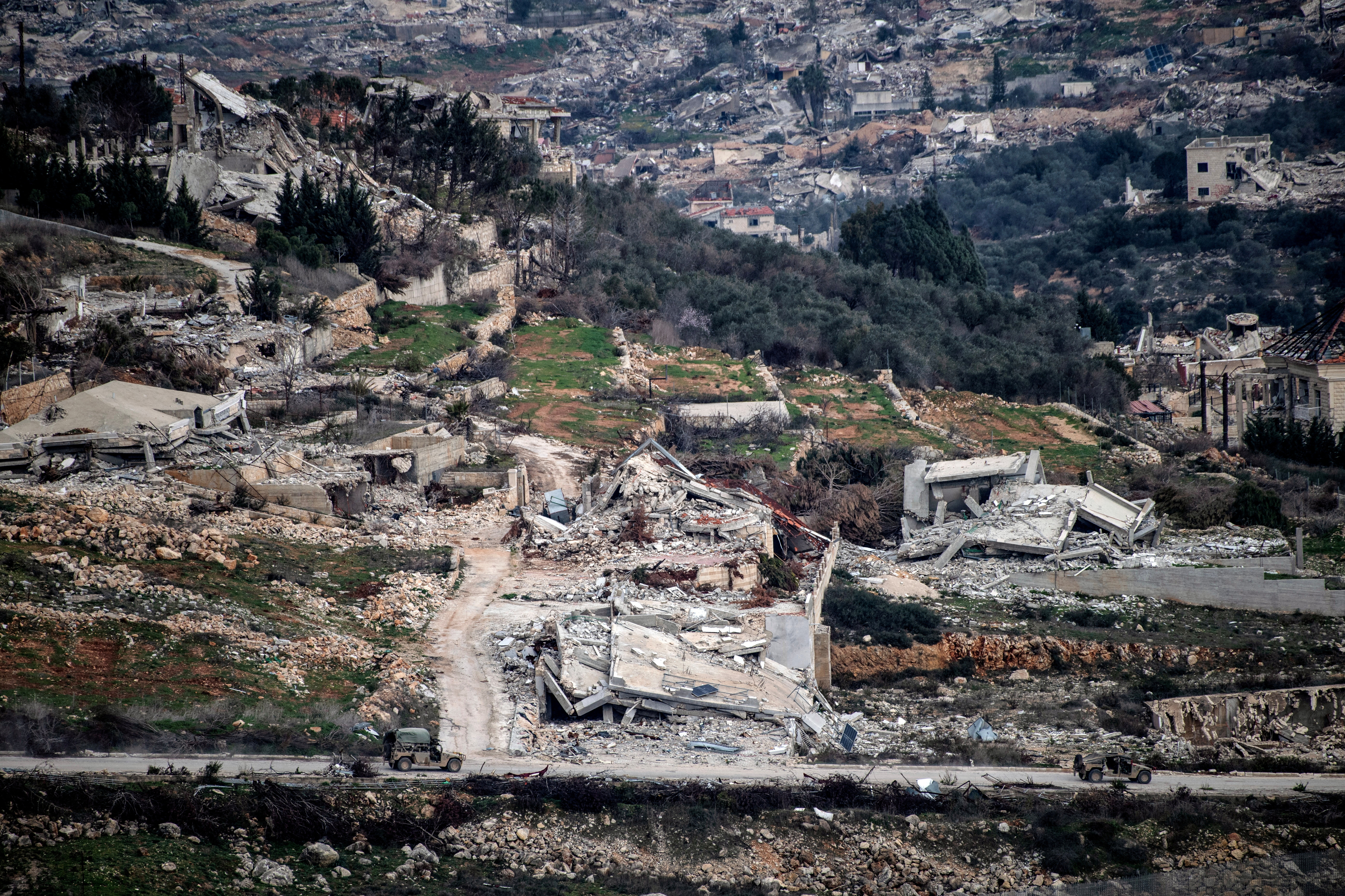Israeli military vehicles drive past destruction in southern Lebanon, as seen from northern Israel, after a ceasefire between Israel and Hezbollah took effect, January 26, 2025. REUTERS/Gil Eliyahu ISRAEL OUT. NO COMMERCIAL OR EDITORIAL SALES IN ISRAEL TPX IMAGES OF THE DAY