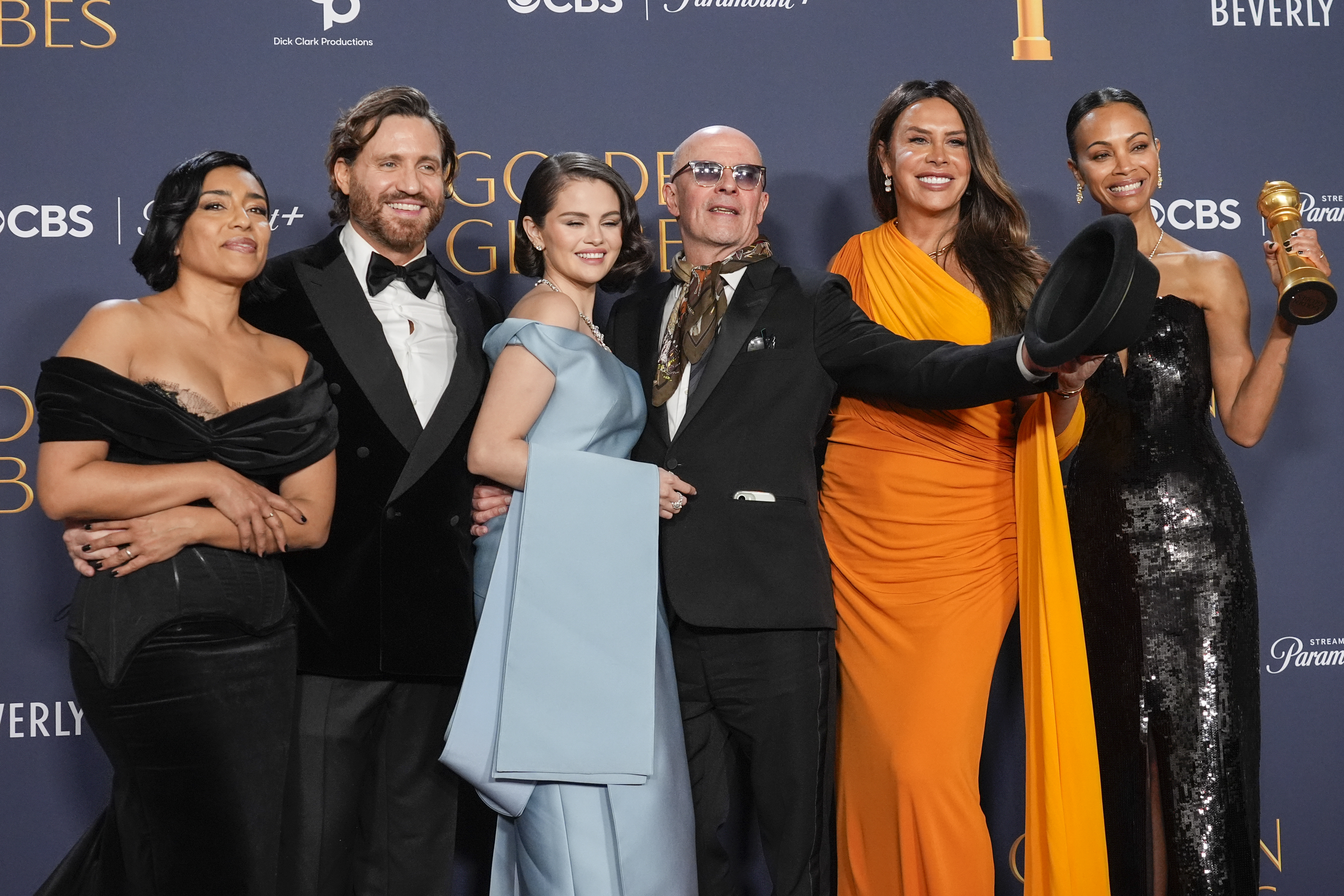 Adriana Paz, from left, Edgar Ramirez, Selena Gomez, Jacques Audiard, Karla Sofia Gascon, and Zoe Saldana pose in the press room with the award for best motion picture.