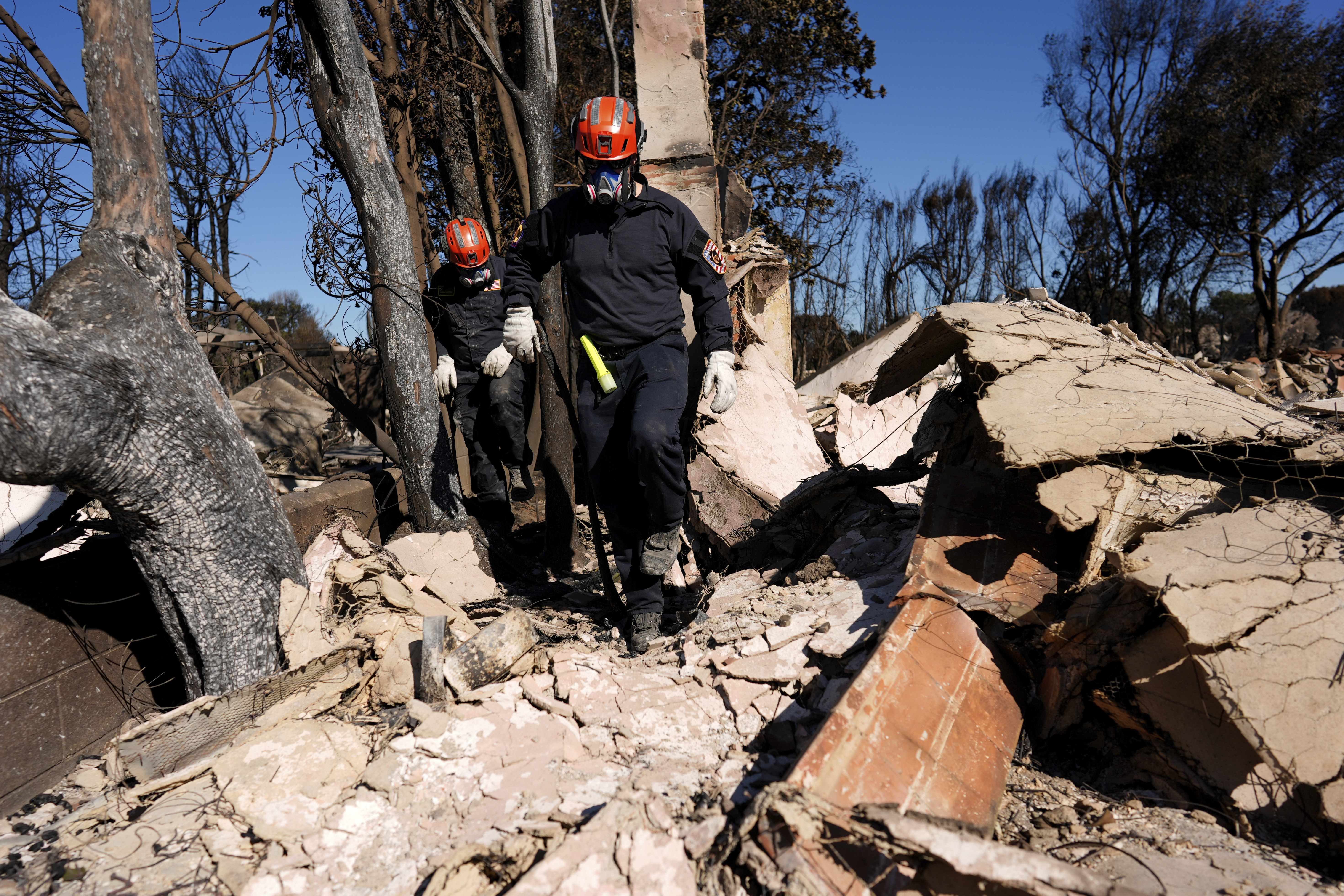 Firefighters comb through rubble in southern California.