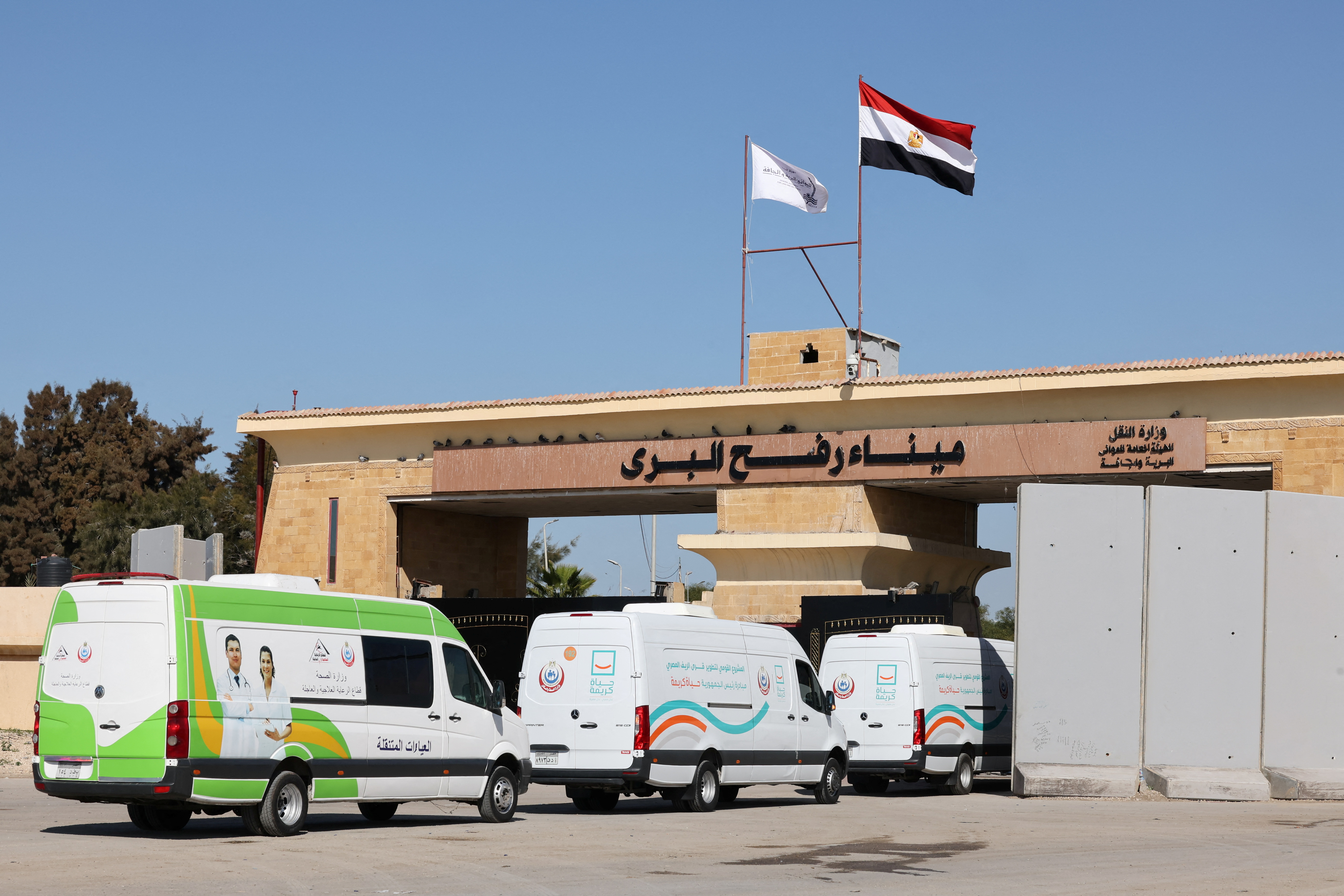 Ambulances drive as the Rafah border crossing between Egypt and the Gaza Strip reopens.
