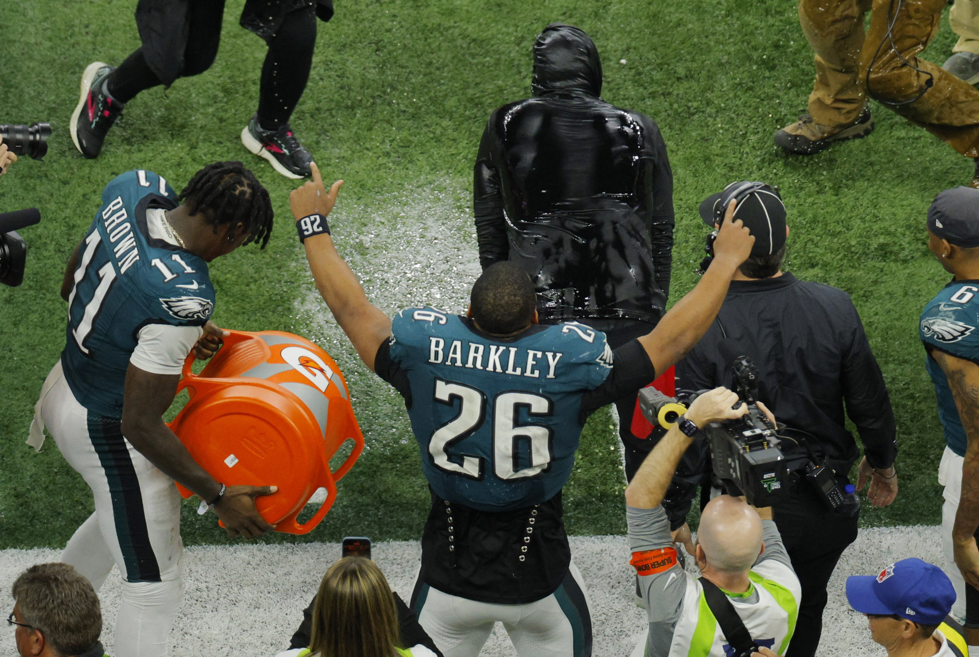 Football - NFL - Super Bowl LIX - Philadelphia Eagles v Kansas City Chiefs - Caesars Superdome, New Orleans, Louisiana, United States - February 9, 2025 Philadelphia Eagles' Saquon Barkley celebrates after A.J. Brown and DeVonta Smith pour Gatorade over head coach Nick Sirianni during the fourth quarter REUTERS/Brian Snyder