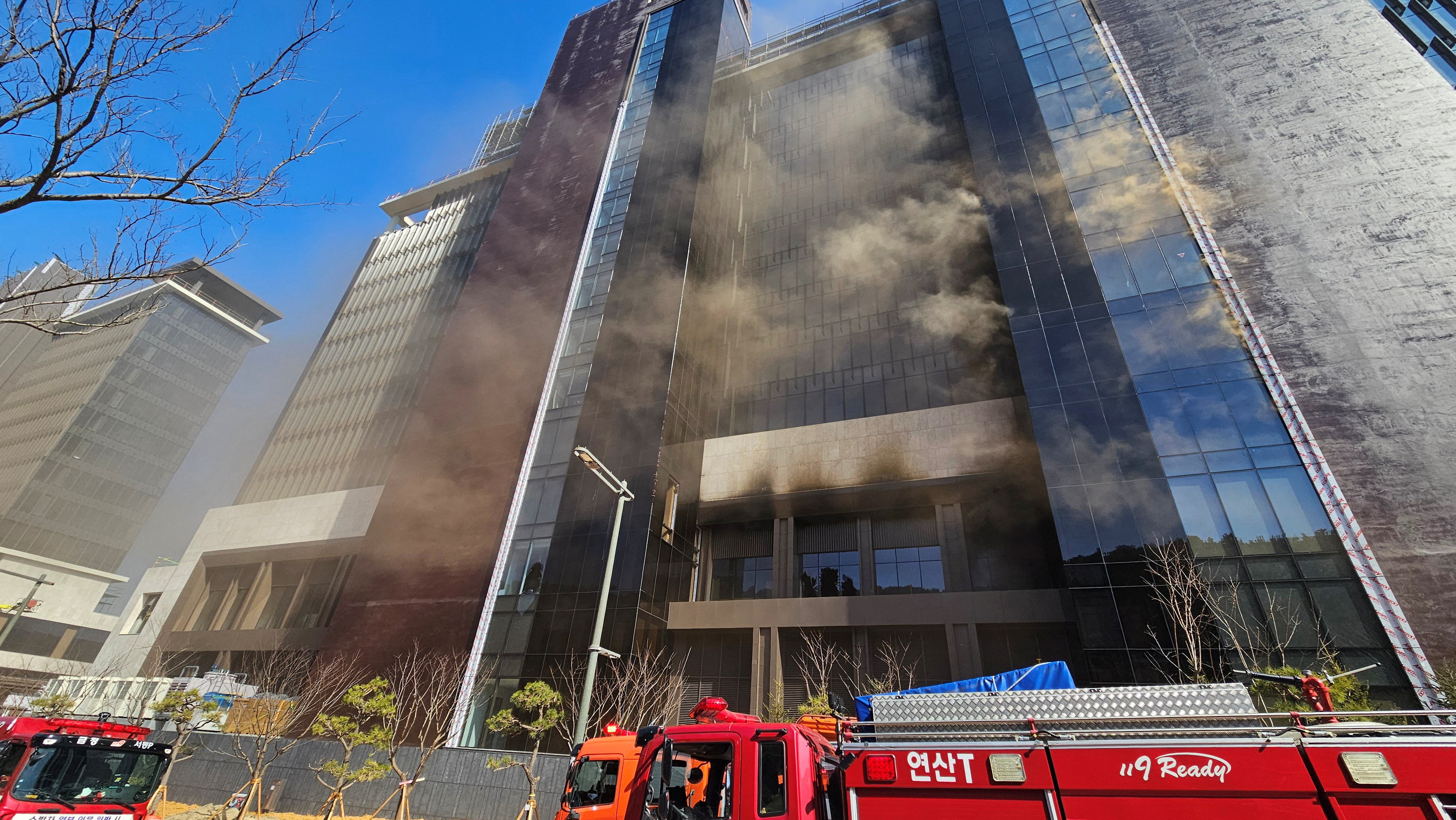 Smoke rises from the site of the fire in a building currently under construction in Busan, South Korea, on February 14, 2025 [Yonhap via Reuters]