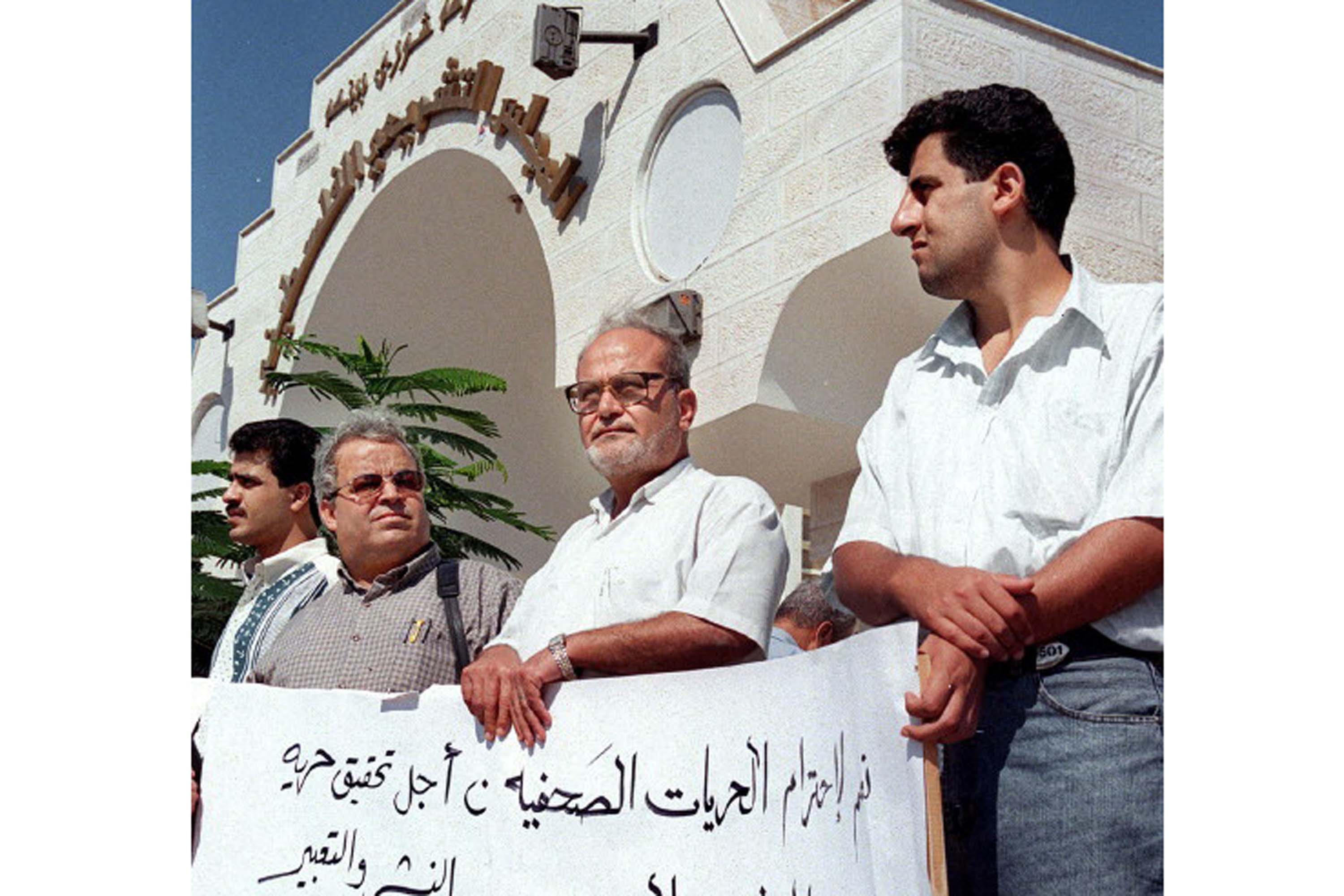 A group of Palestinian journalists protest in front of the Palestinian Legislative Council headquarters in Gaza City 17 October 1999, against the continued closure of the Bethlehem-based private TV channel, Al-Roah, closed by the Palestinian Authority four months ago. Some 50 protesters carried banners calling for freedom of expression in the Palestinian self-rule areas. (Photo by MOHAMMAD SABER / AFP)