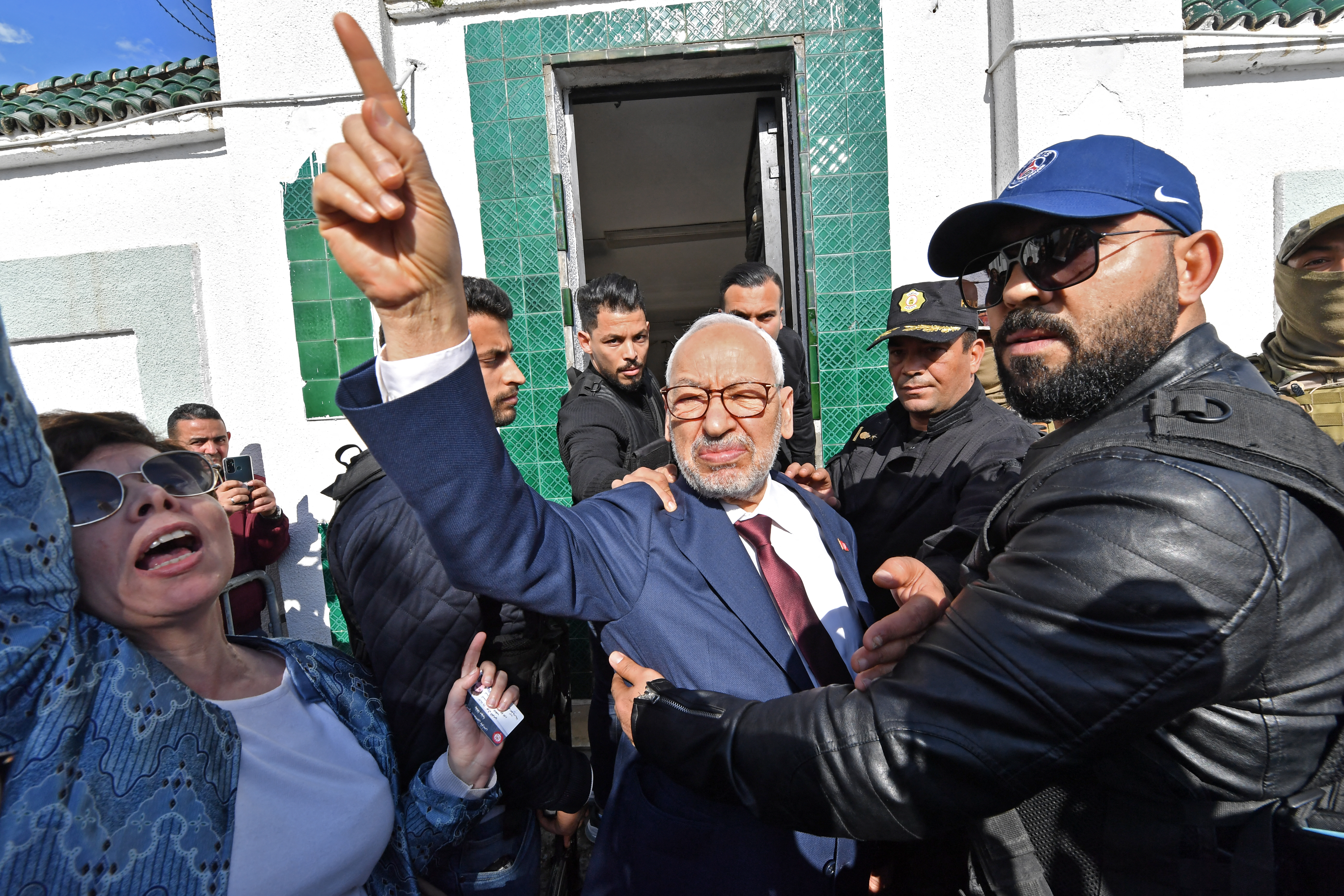 Tunisia's Speaker of the Parliament Rached Ghannouchi flashes the victory sign as he arrives for questioning at the judicial police headquarters in the capital Tunis