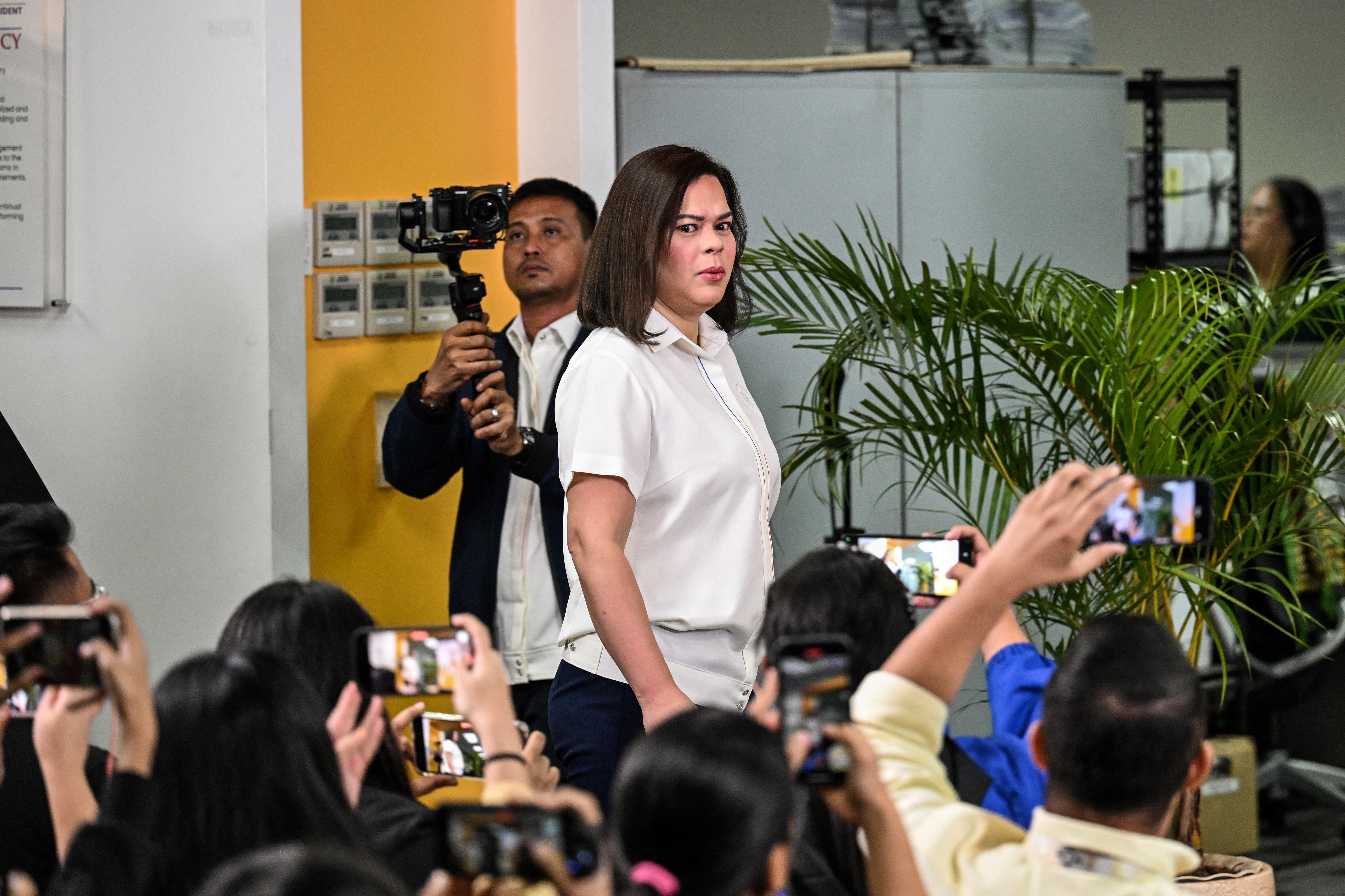 Philippine Vice President Sara Duterte arrives at a press conference to give a statement on impeachment complaints filed against her at her office in Mandaluyong, Metro Manila on February 7, 2025. Duterte said she had yet to consider stepping down and was still weighing a run for president despite her dramatic impeachment this week by the House of Representatives. (Photo by JAM STA ROSA / AFP)