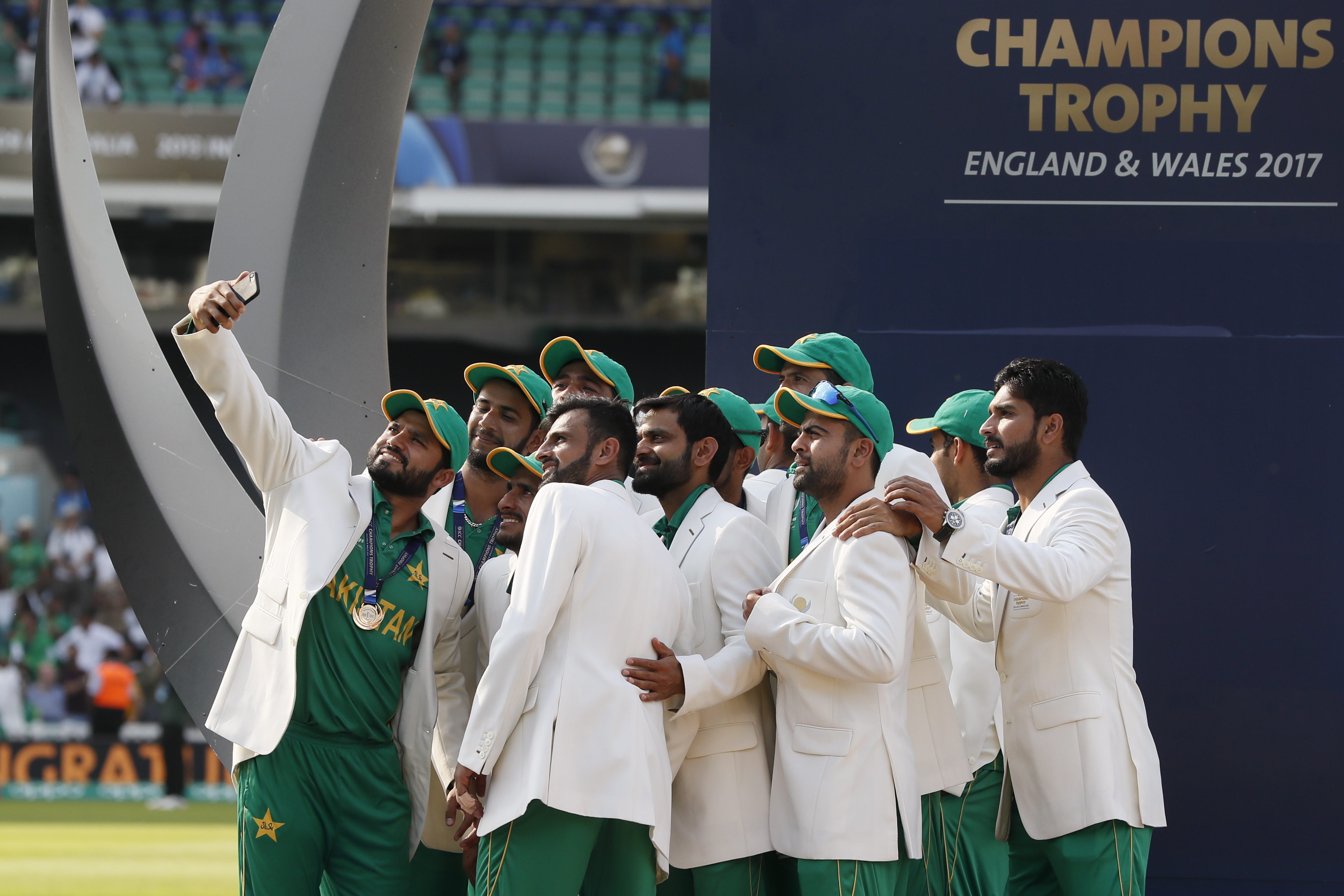 Pakistan players take a selfie at the podium during an award ceremony.
