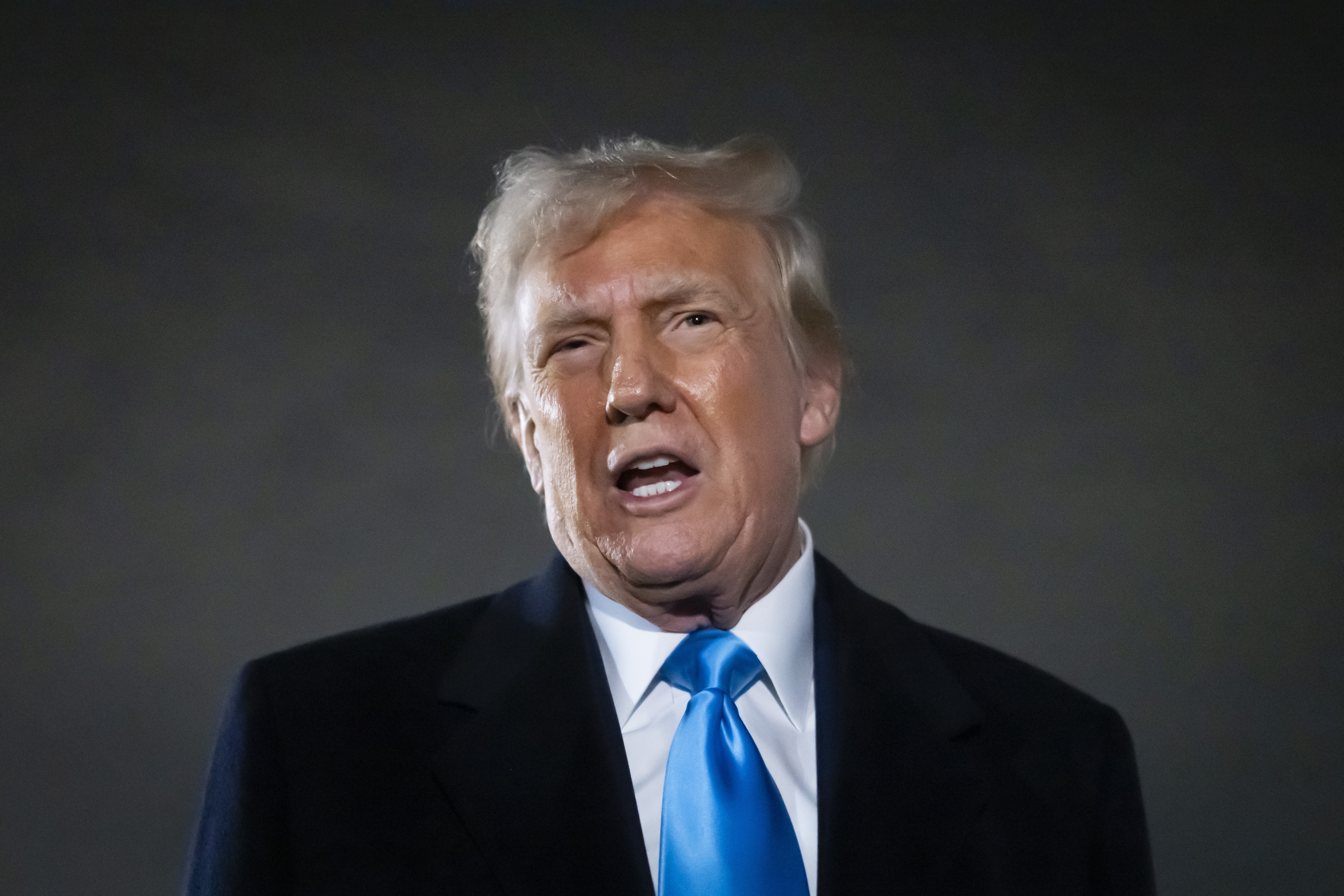President Donald Trump speaks to reporters next to Air Force One after arriving back at Joint Base Andrews, M