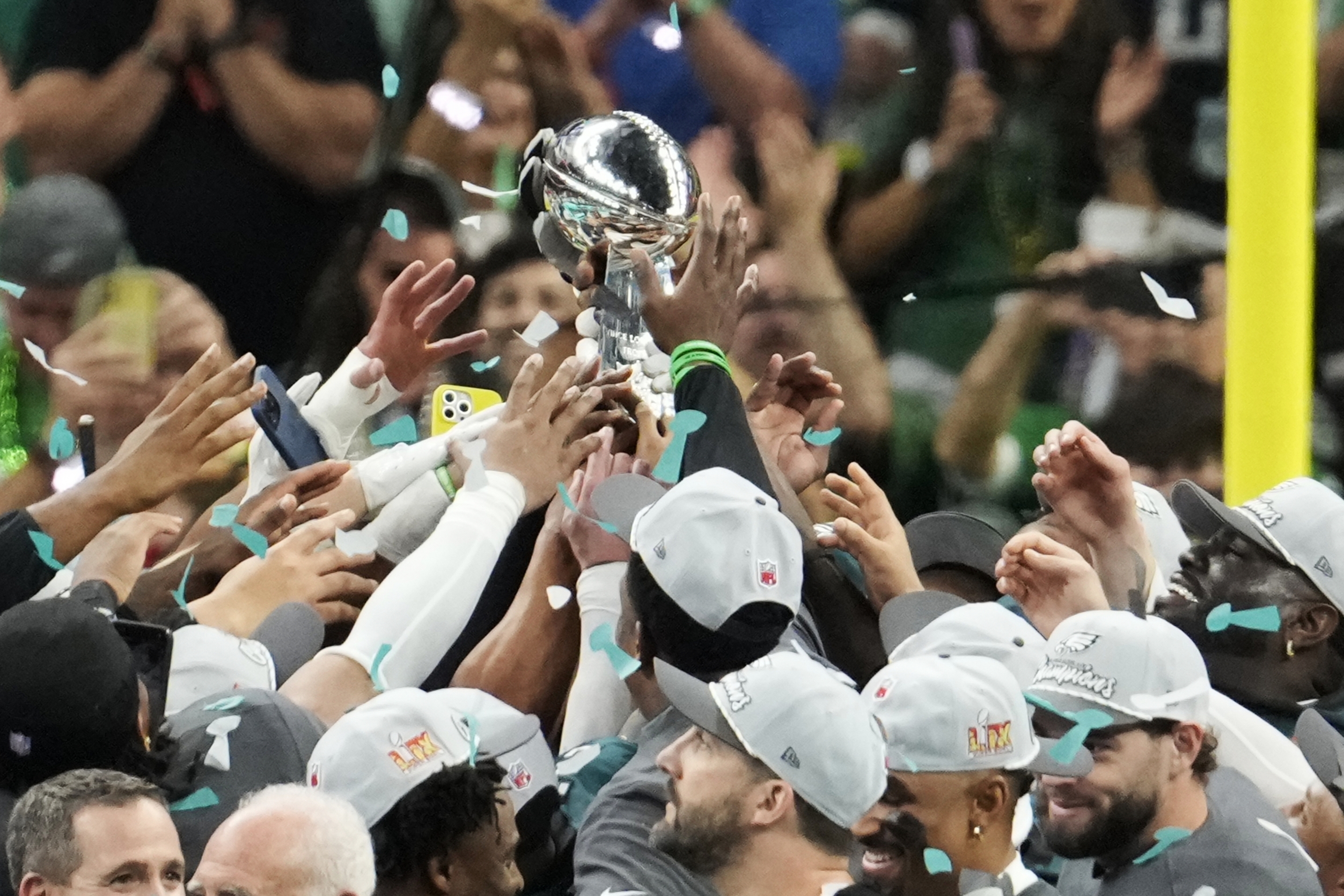 Philadelphia Eagles players holds the Vince Lombardi Trophy after the NFL Super Bowl 59 football game against the Kansas City Chiefs, Sunday, Feb. 9, 2025, in New Orleans. (AP Photo/Gerald Herbert)