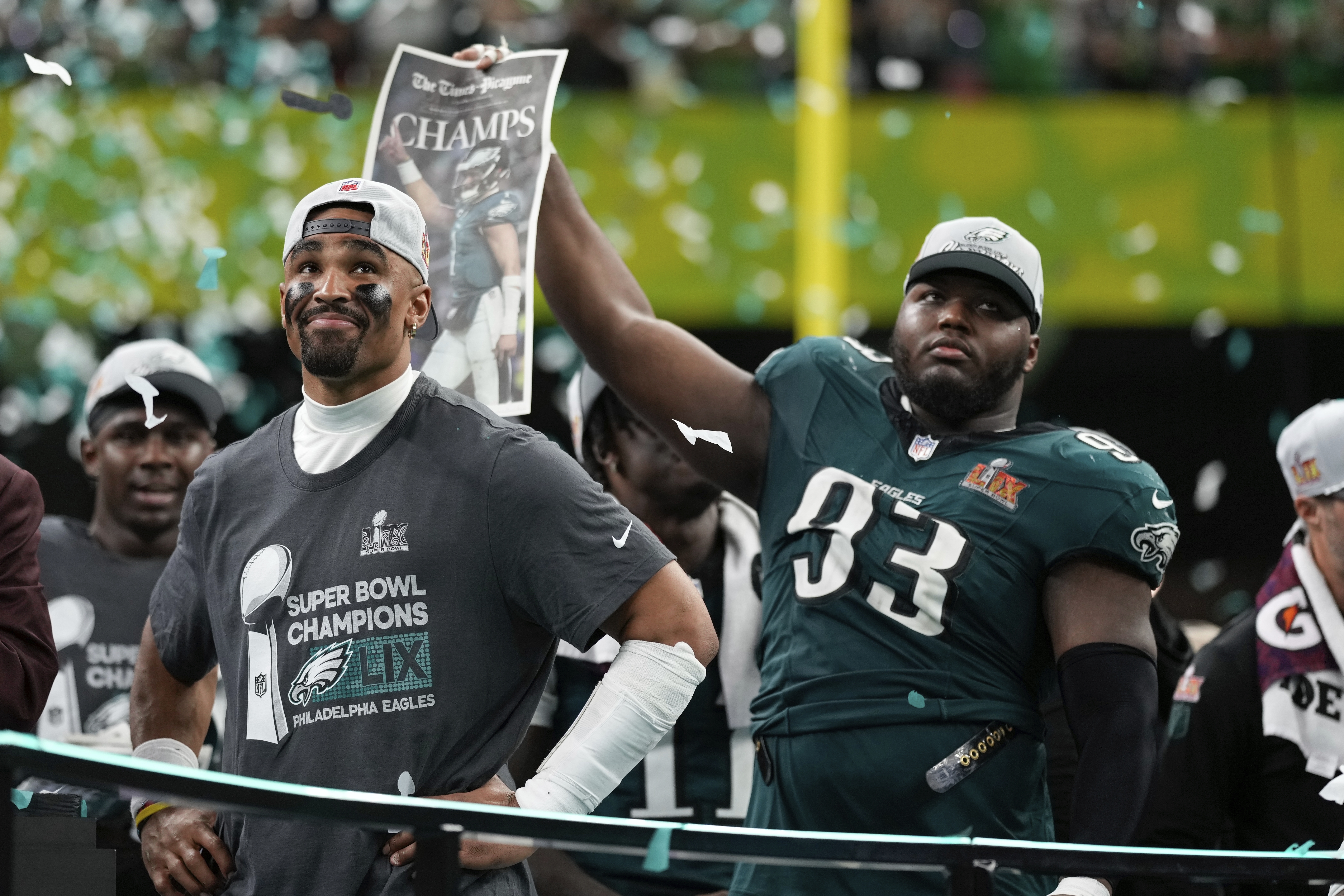 Philadelphia Eagles quarterback Jalen Hurts smiles on the podium next to defensive tackle Milton Williams (93) after a win over the Kansas City Chiefs during the NFL Super Bowl 59 football game, Sunday, Feb. 9, 2025, in New Orleans. (AP Photo/Matt Slocum)