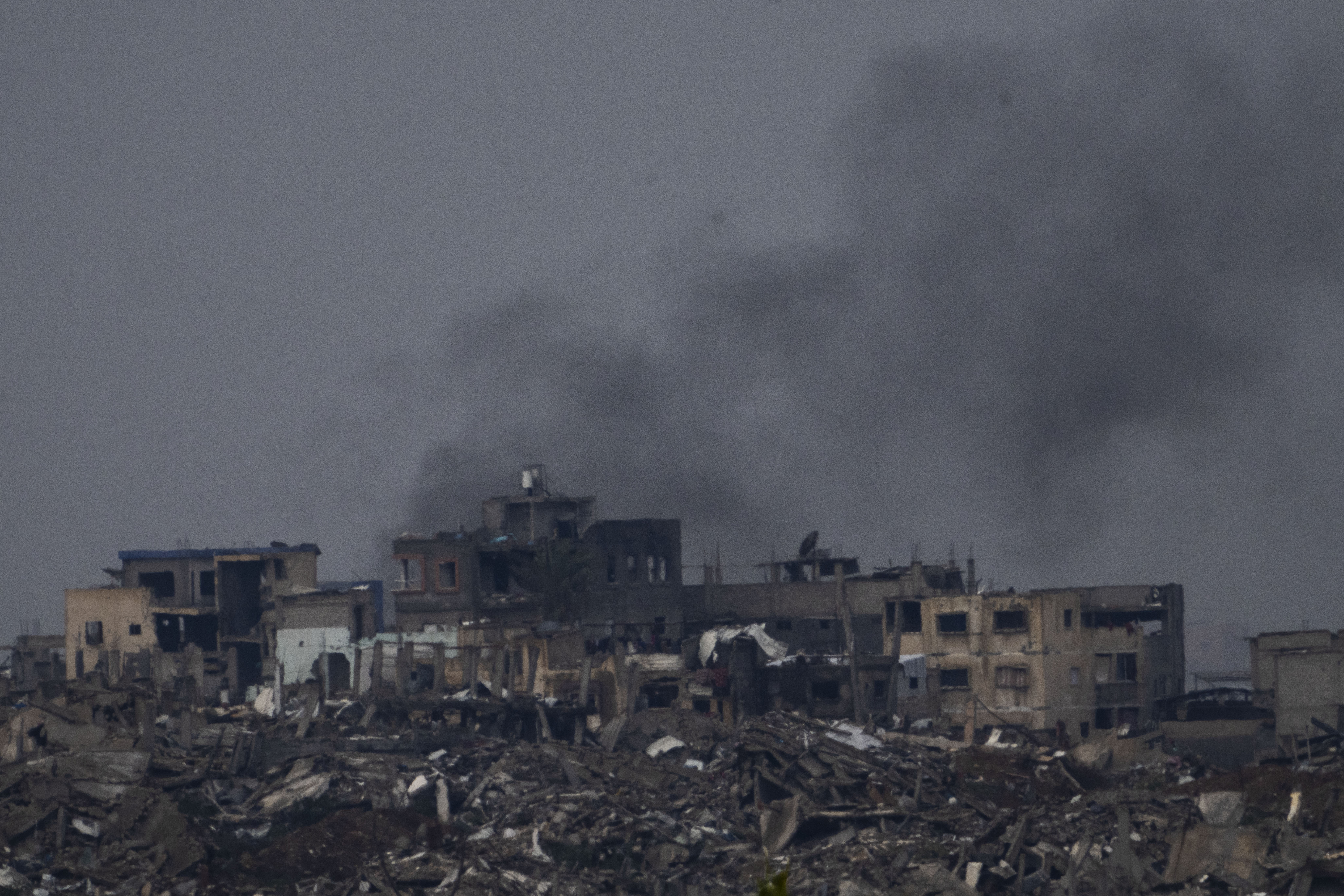 Destroyed buildings by Israeli bombardments inside the northern Gaza Strip as seen from southern Israel, Tuesday, Feb.11, 2025. (AP Photo/Ariel Schalit)
