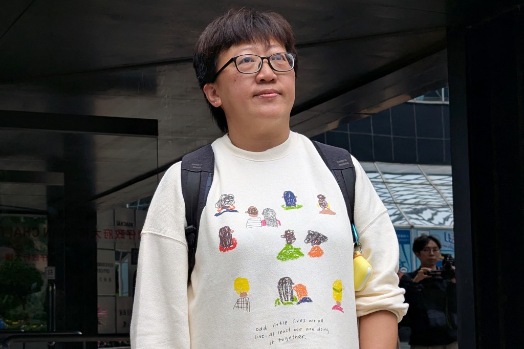 Social worker Jackie Chen looks on outside the District Court in Hong Kong before she was convicted of rioting in relation to Hong Kong's 2019 pro-democracy protests. [Photo by Holmes Chan/AFP]