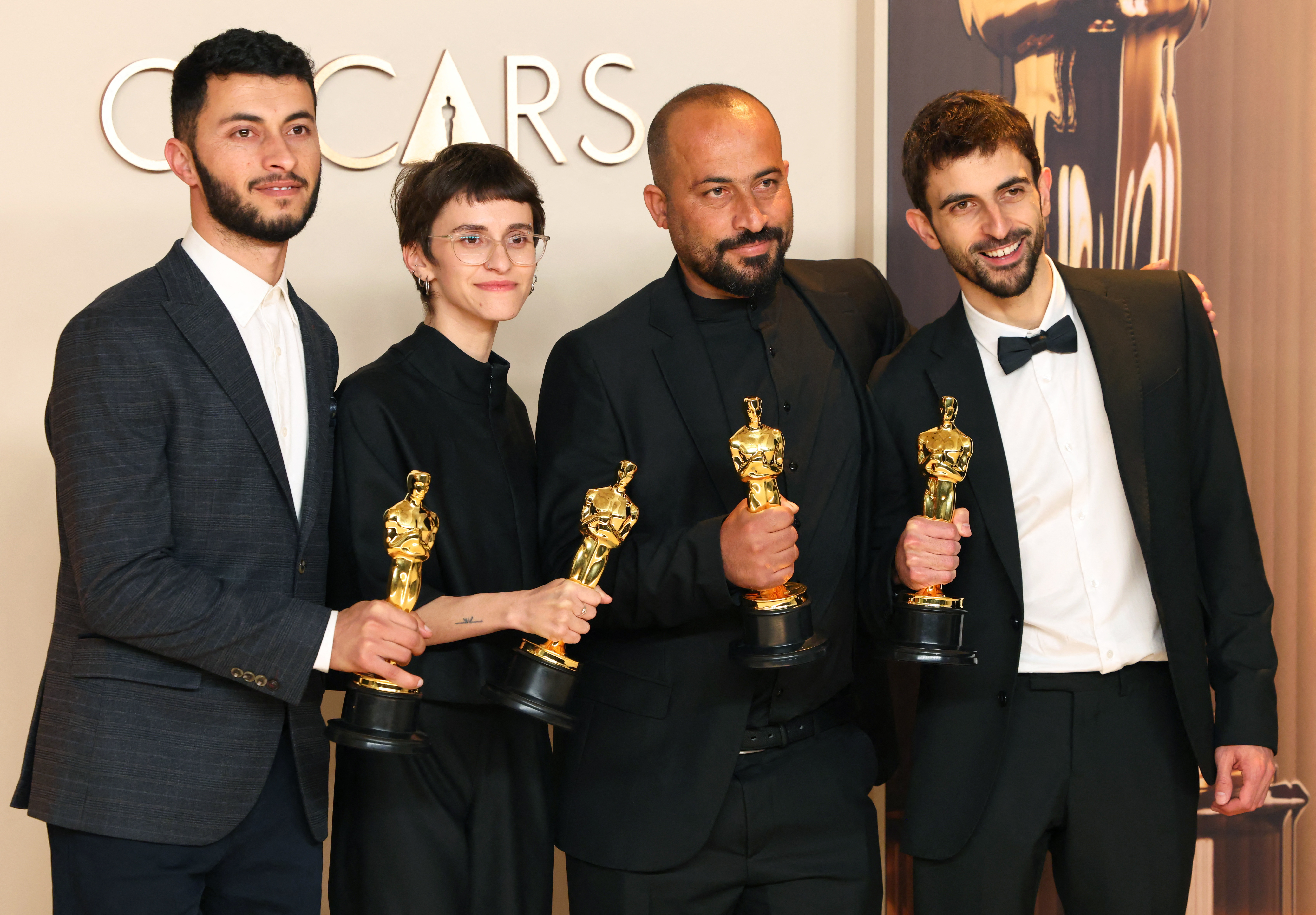Basel Adra, Rachel Szor, Hamdan Ballal and Yuval Abraham pose with the Oscar for Best Documentary Feature Film for "No Other Land" in the Oscars photo room at the 97th Academy Awards in Hollywood, Los Angeles, California