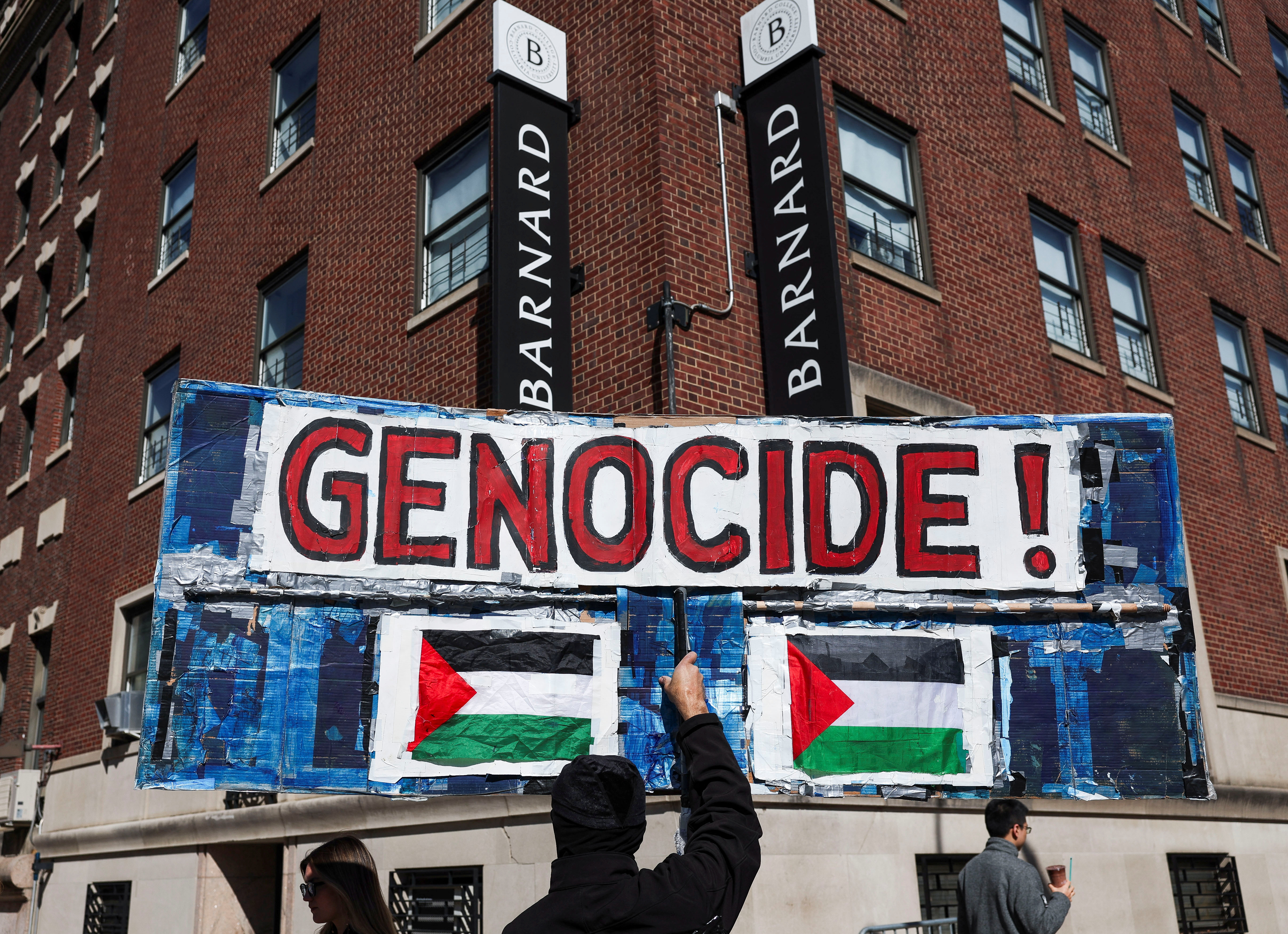 A person holds a banner during a protest following the arrest by US. immigration agents of student protester Mahmoud Khalil at Columbia University