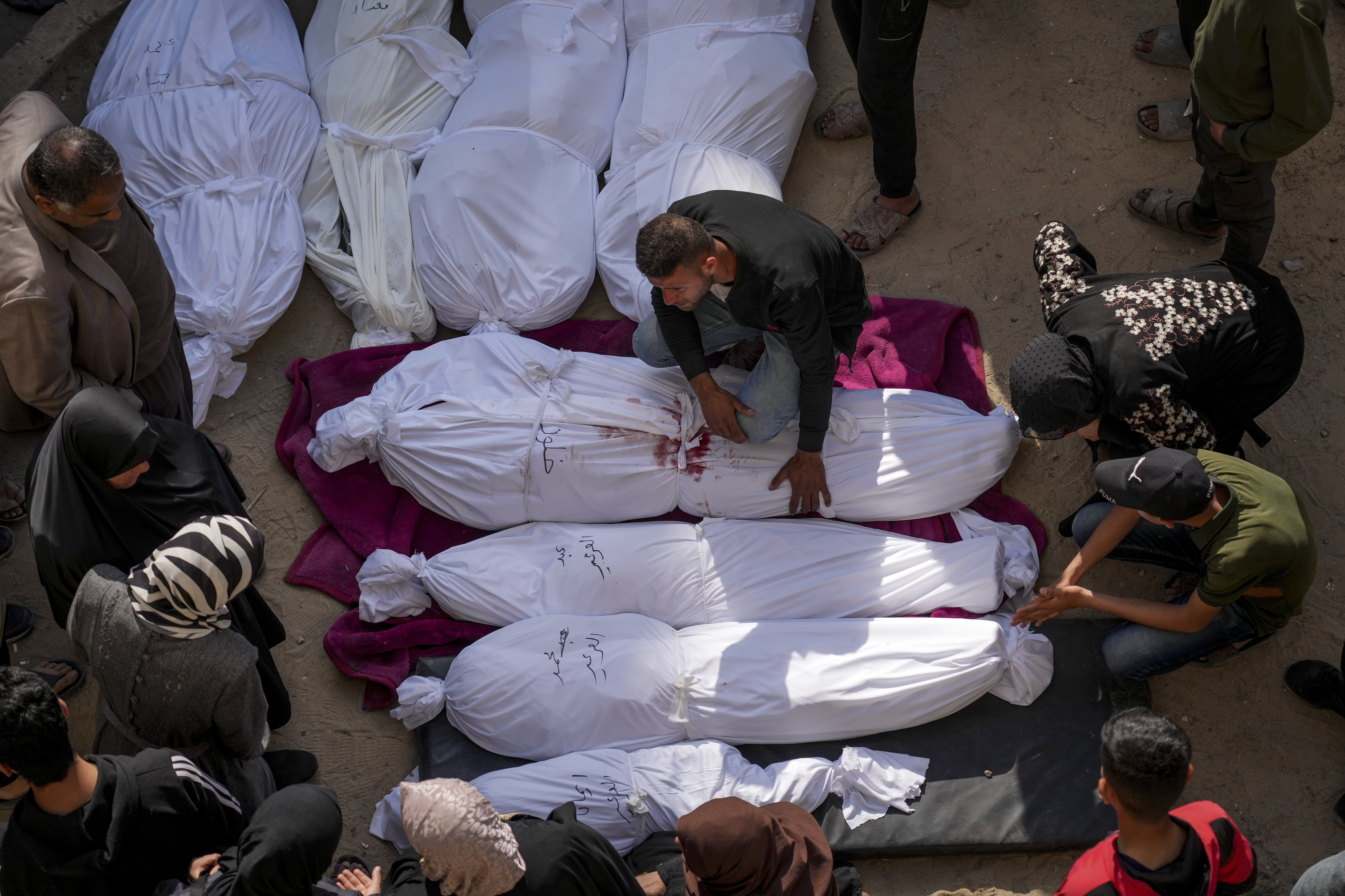 Mourners gather around the bodies of Palestinians who were killed in an Israeli army airstrikes as they are brought to Al-Ahli Hospital in Gaza City