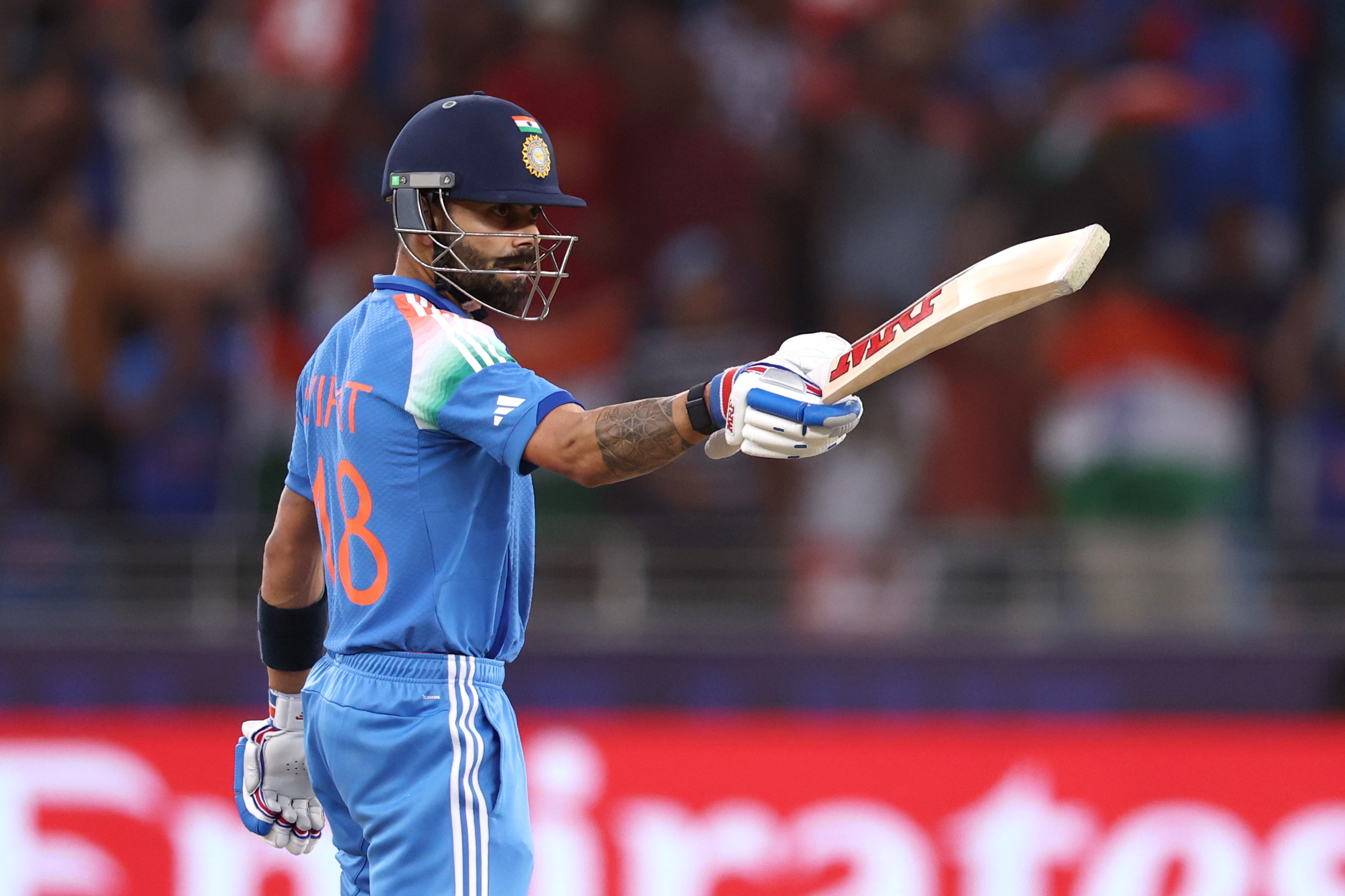 DUBAI, UNITED ARAB EMIRATES - MARCH 04: Virat Kohli of India salutes the crowd after reaching his half century during the ICC Champions Trophy 2025 semi final between India and Australia at Dubai International Cricket Stadium on March 04, 2025 in Dubai, United Arab Emirates. (Photo by Francois Nel/Getty Images)