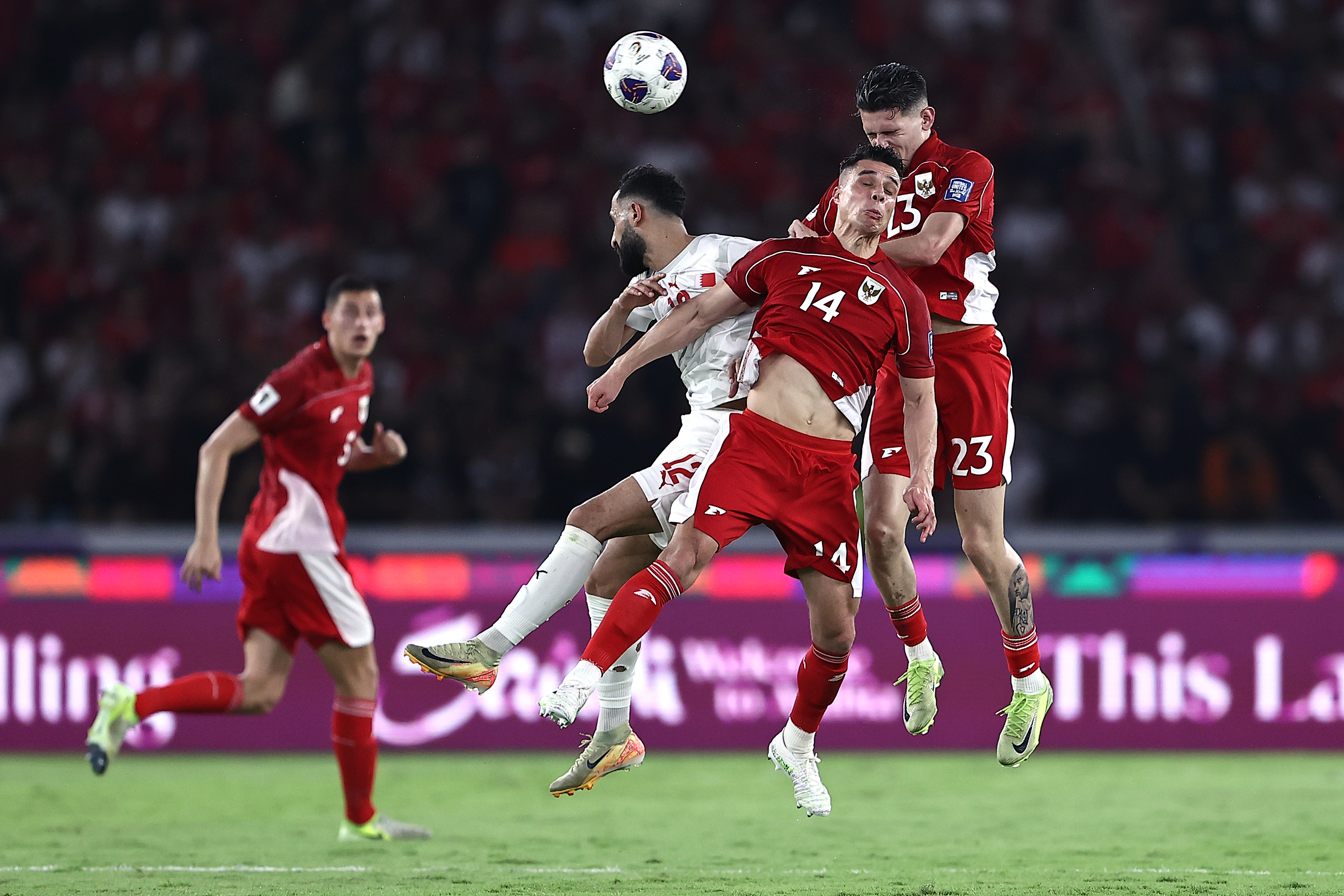 JAKARTA, INDONESIA - MARCH 25: (L-R) Mahdi Abdul Jabar Hasan of Bahrain, Joey Pelupessy, and Justin Hubner of Indonesia hea during the FIFA World Cup qualifier Asian third round Group C match between Indonesia and Bahrain at Gelora Bung Karno Stadium on March 25, 2025 in Jakarta, Indonesia. (Photo by Robertus Pudyanto/Getty Images)