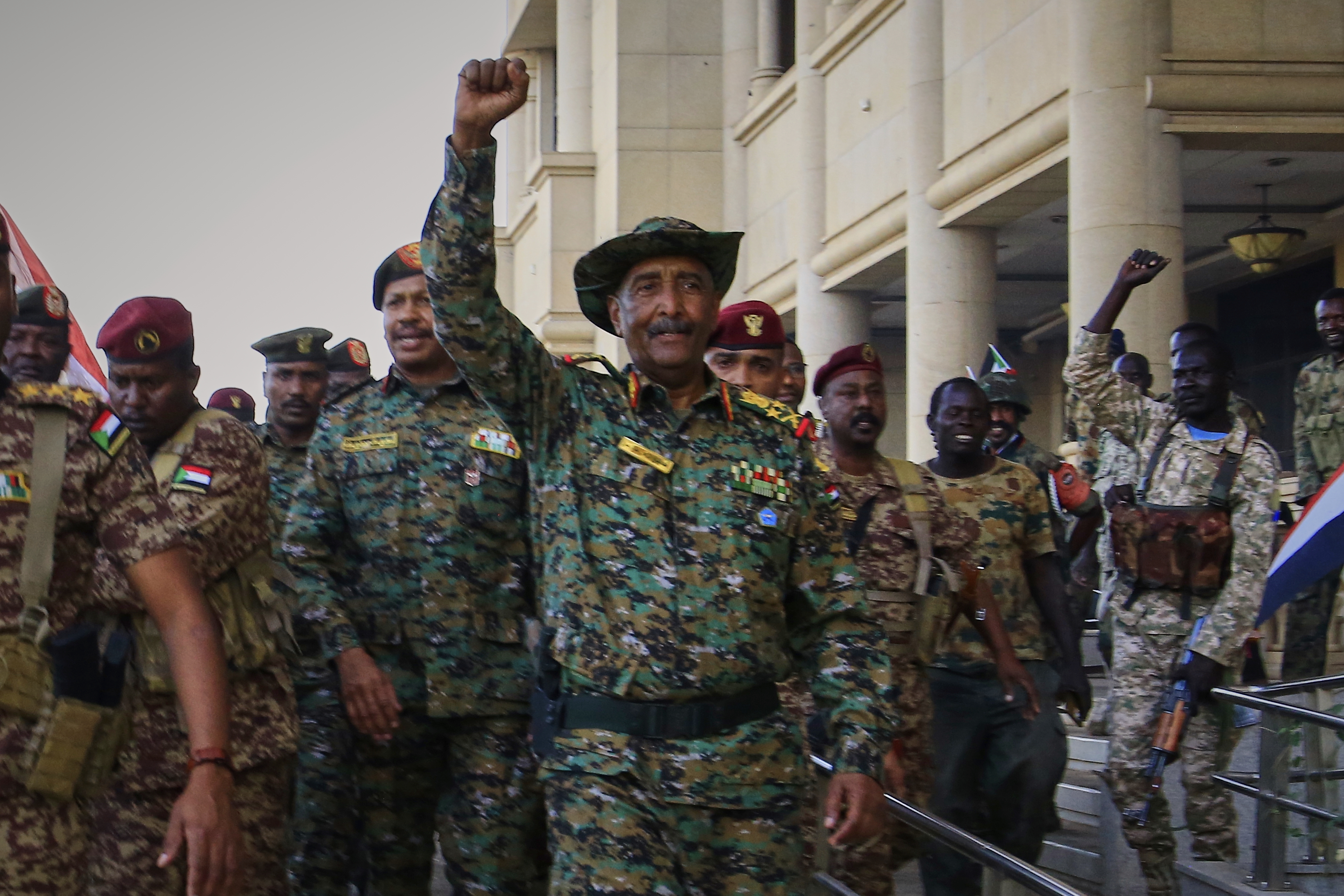 Sudan's military chief Gen. Abdel-Fattah Burhan center, is greeted by troops as he arrives at the Republican Palace, recently recaptured from the Rapid Support Forces paramilitary group, in Khartoum, Sudan, Wednesday, March 26, 2025. (AP Photo)