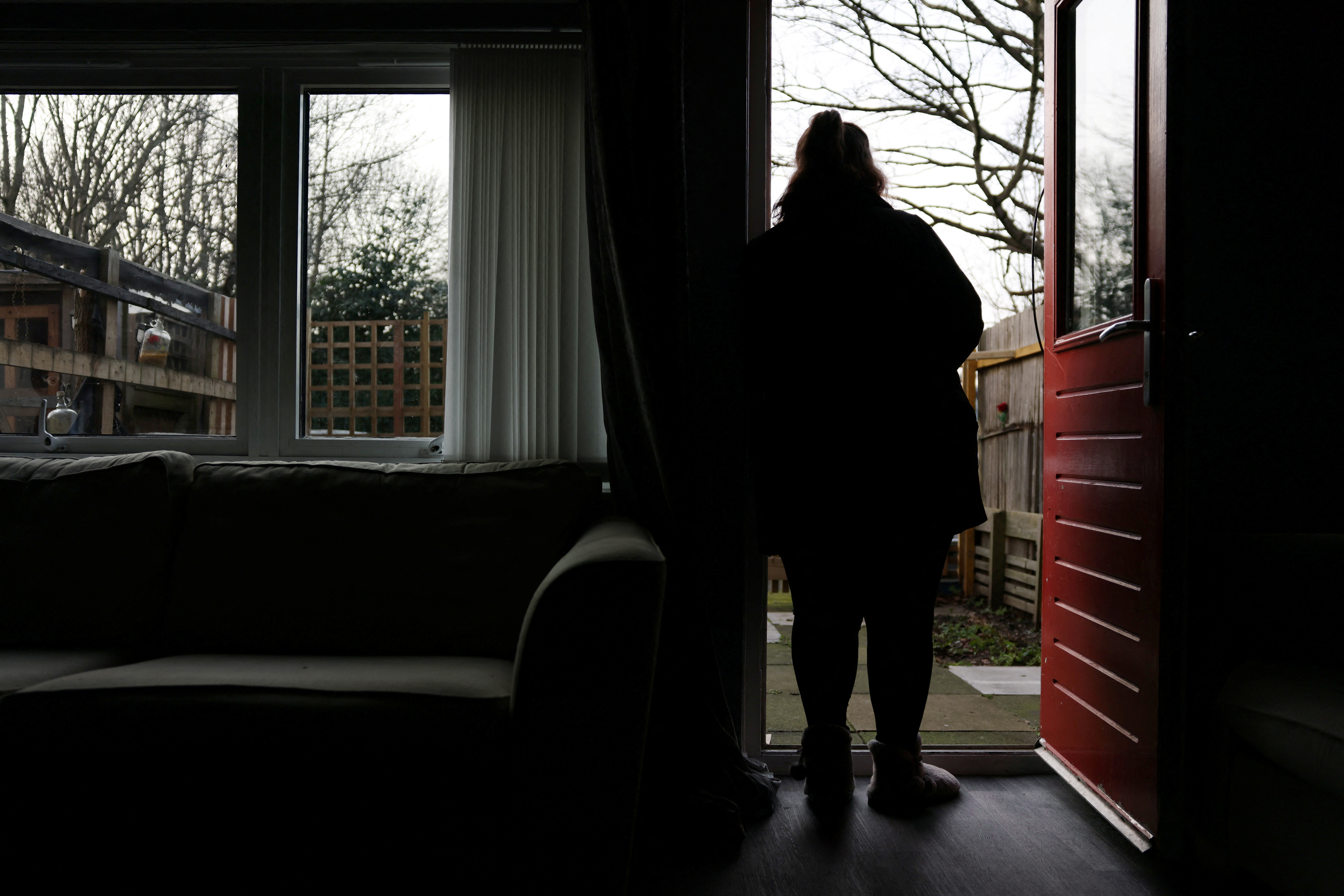 A woman poses at her home in England, Britain, January 8, 2025. She was 14 when she was sexually abused by a grooming gang in Rochdale. REUTERS/Hollie Adams
