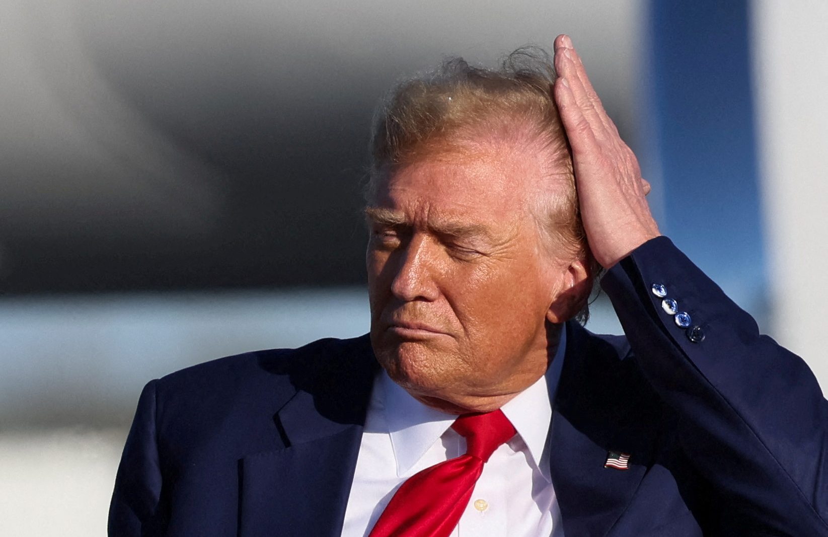 Republican presidential candidate and former U.S. President Donald Trump combs his hair during a campaign event in Freeland, Michigan, U.S. May 1, 2024.