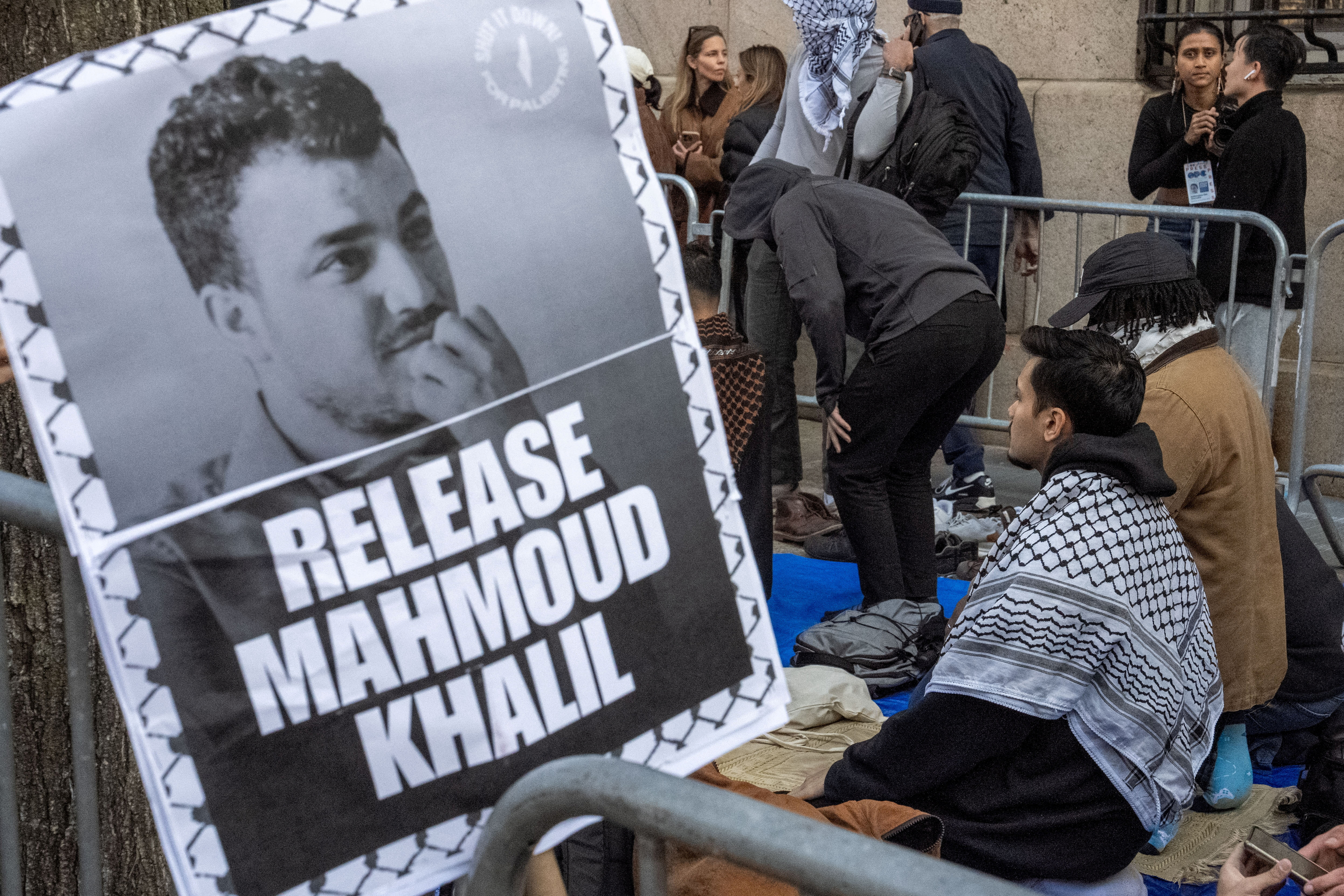 Protesters next to a sign calling for the release of Mahmoud Khalil