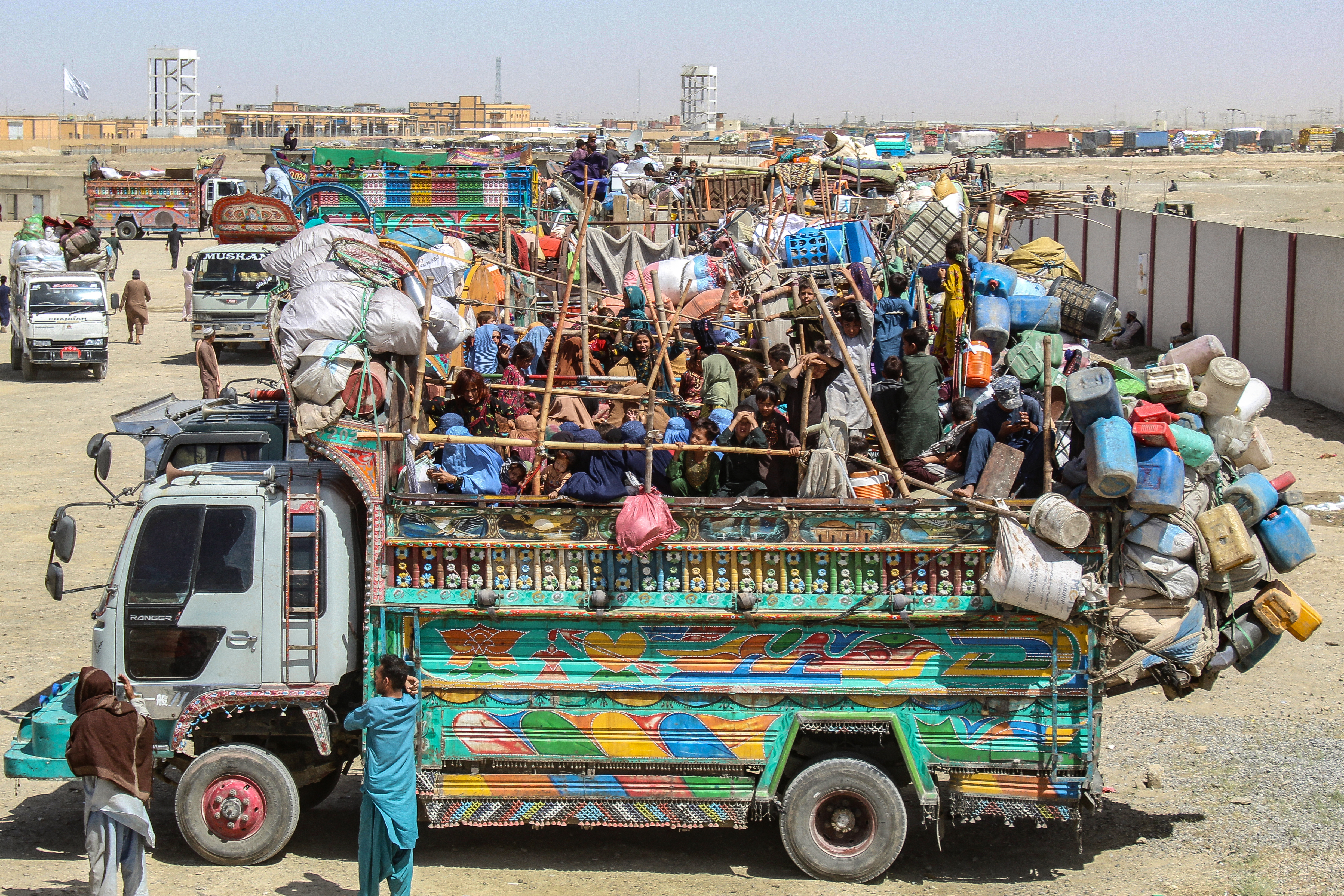 A truck filled with Afghan refugees and loaded with their belongings waits to depart for Afghanistan.