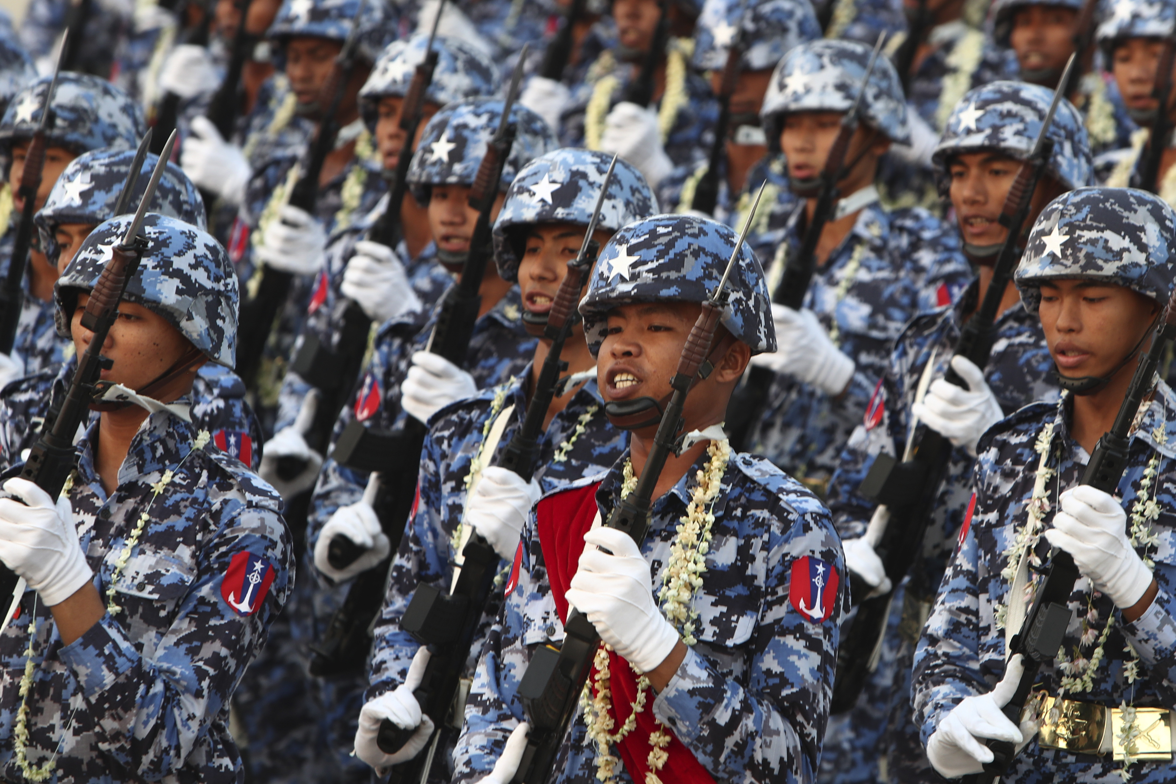 Military officers march during a parade.