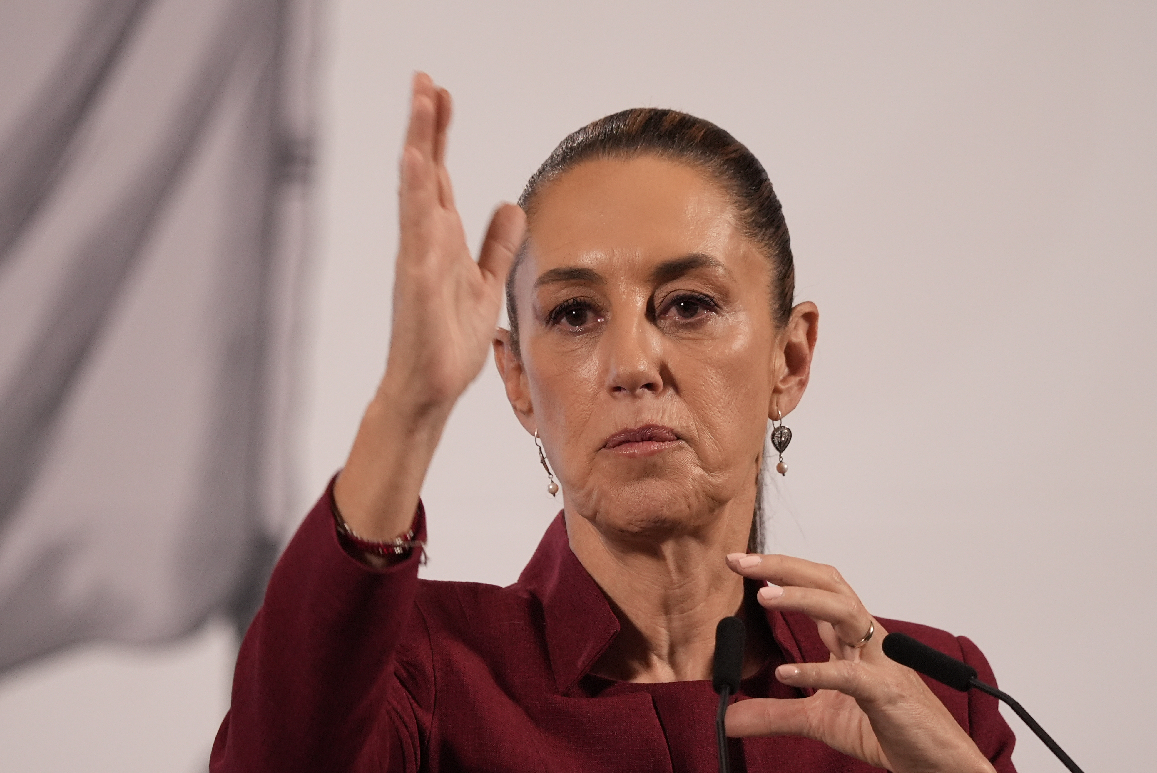 Claudia Sheinbaum speaking with hands raised in gesture