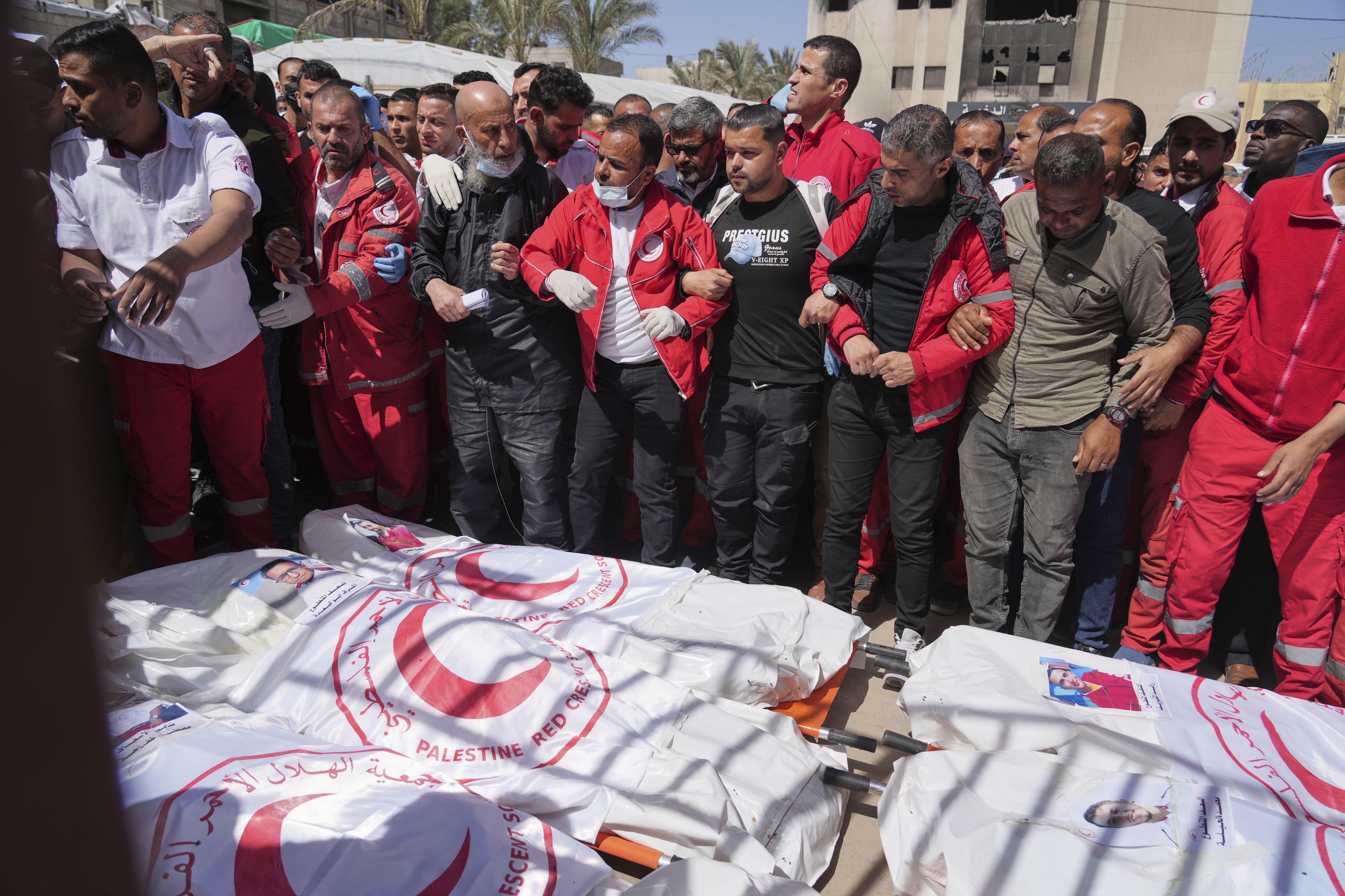 Mourners gather around the bodies of eight Red Crescent emergency responders.
