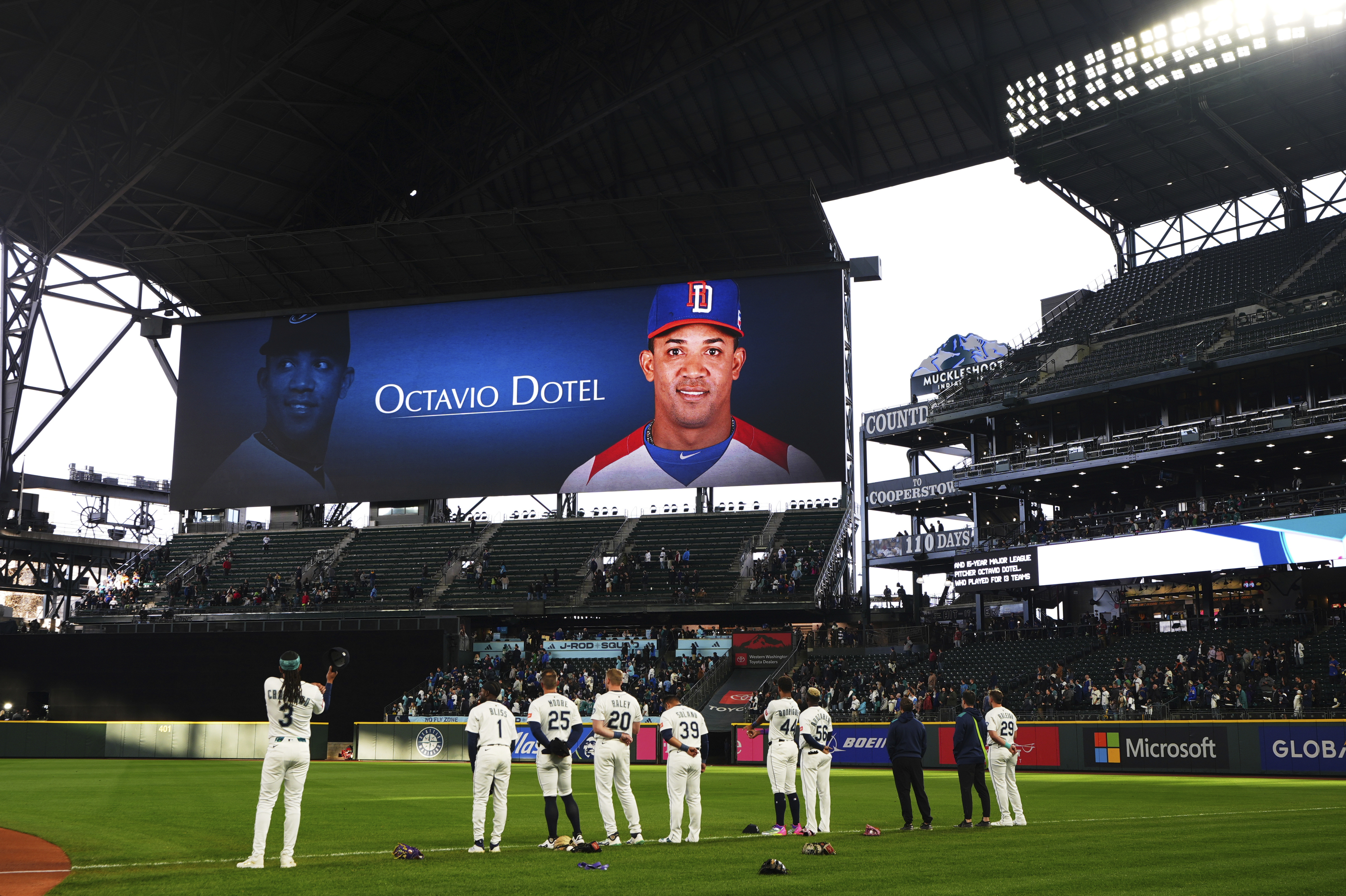 Members of the Seattle Mariners stand during a moment of silence for Octavio Dotel.