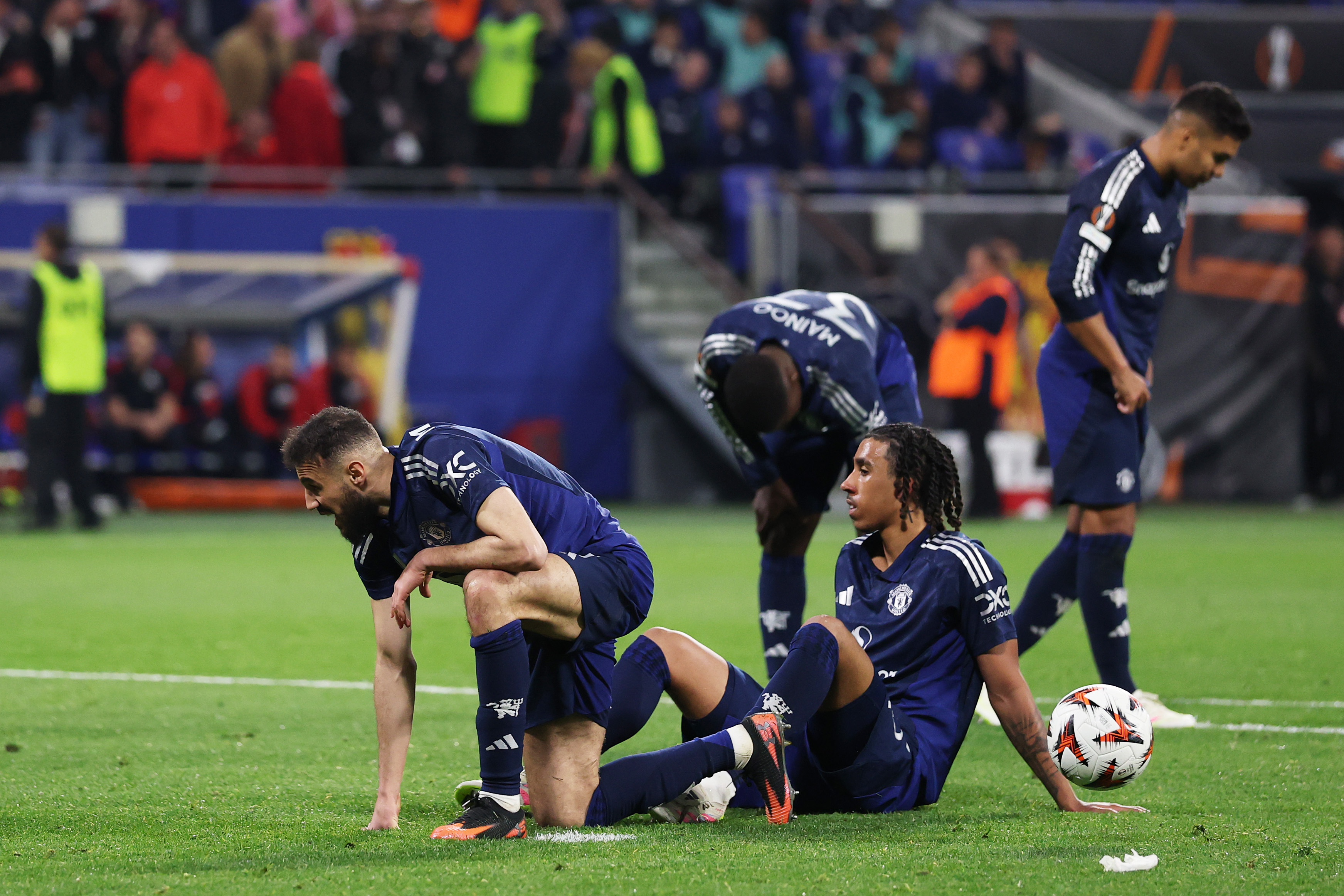 DECINES-CHARPIEU, FRANCE - APRIL 10: Noussair Mazraoui, Leny Yoro, Kobbie Mainoo and Casemiro of Manchester United look dejected at the final whistle after drawing 2-2 with Olympique Lyonnais in the UEFA Europa League 2024/25 Quarter Final First Leg match between Olympique Lyonnais and Manchester United at OL Stadium on April 10, 2025 in Decines-Charpieu, France. (Photo by Michael Steele/Getty Images)