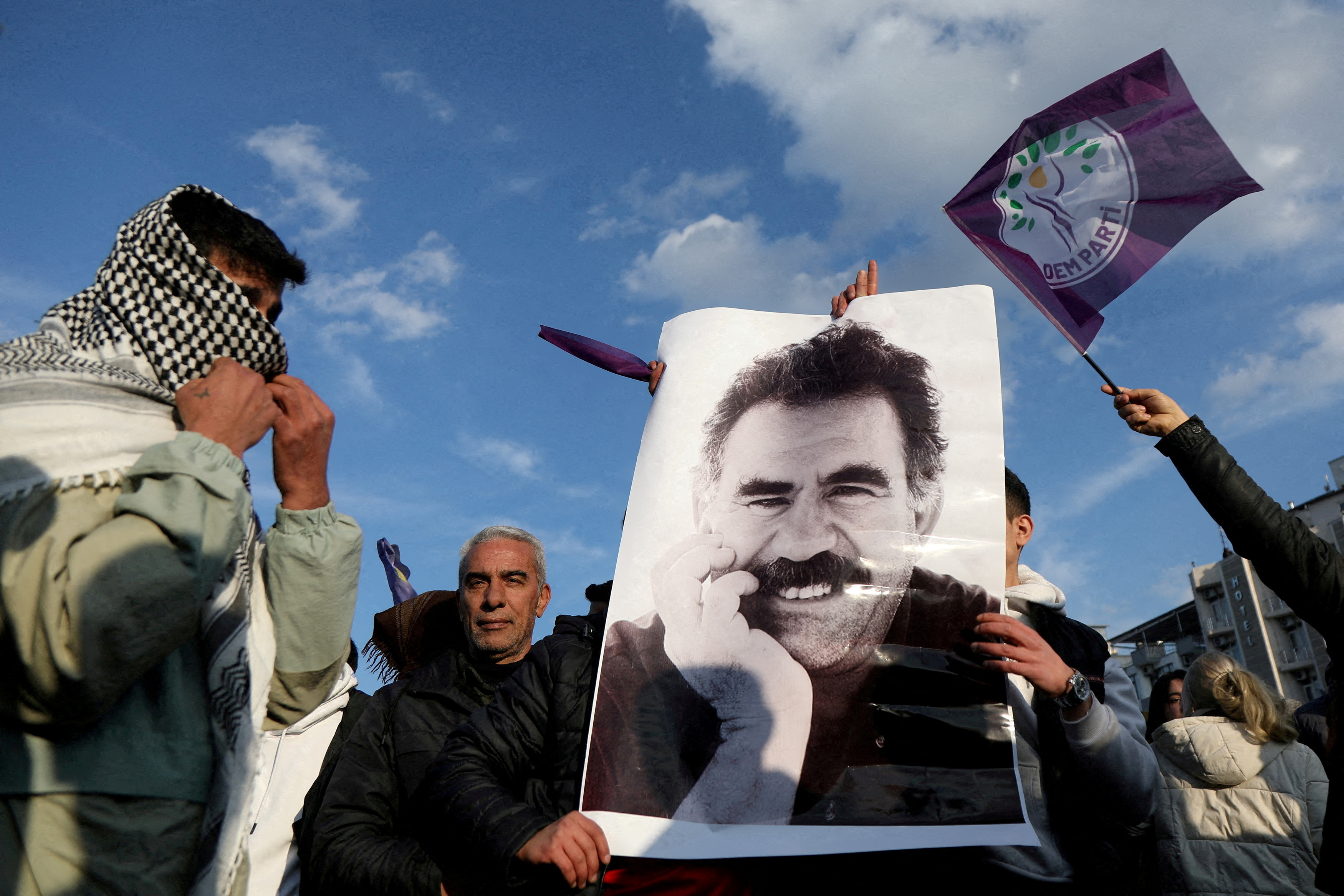 A demonstrator holds a picture of jailed Kurdish leader Abdullah Ocalan during a rally in Diyarbakir, Turkiye