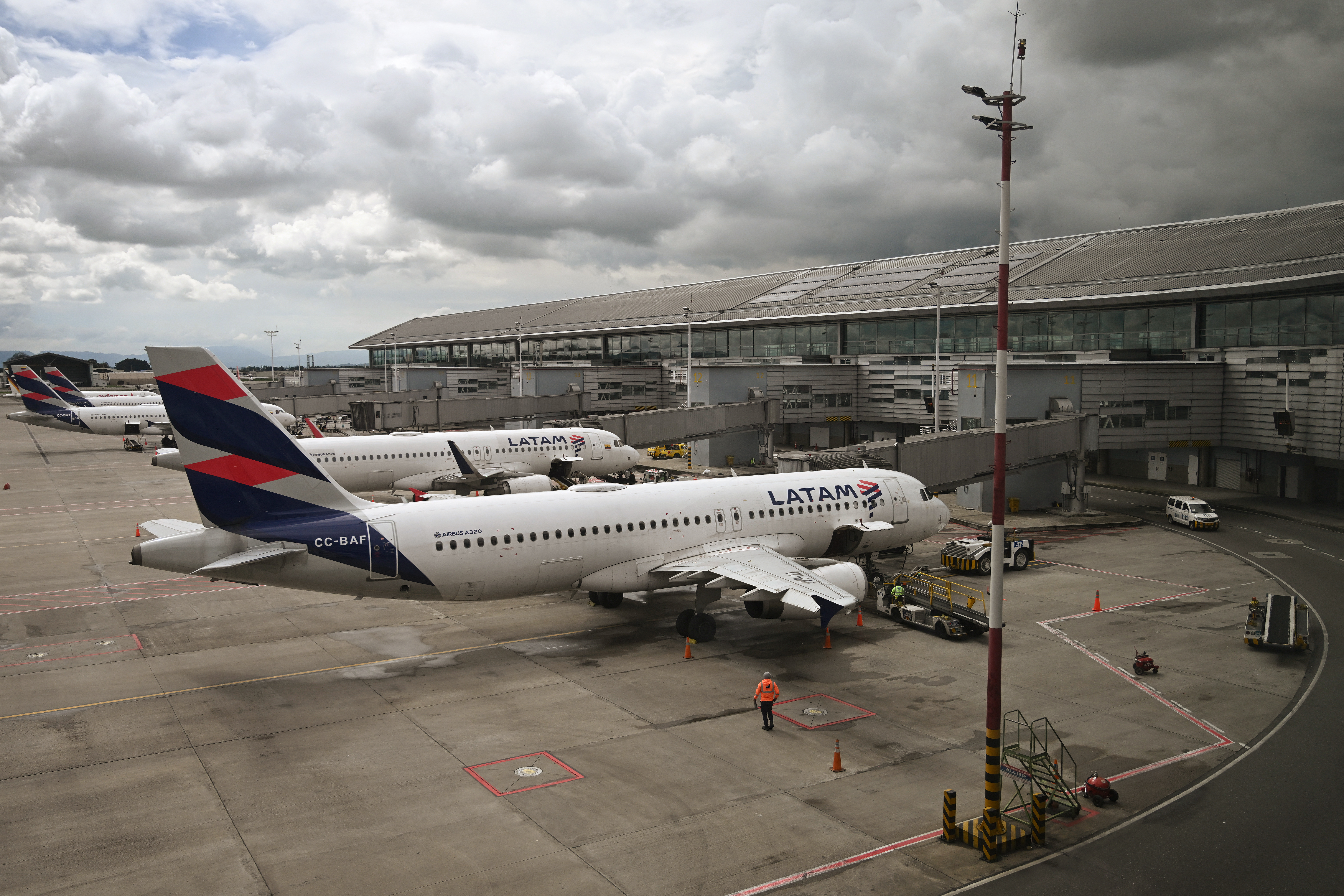 LATAM airline planes are pictured on the tarmac at an airport.