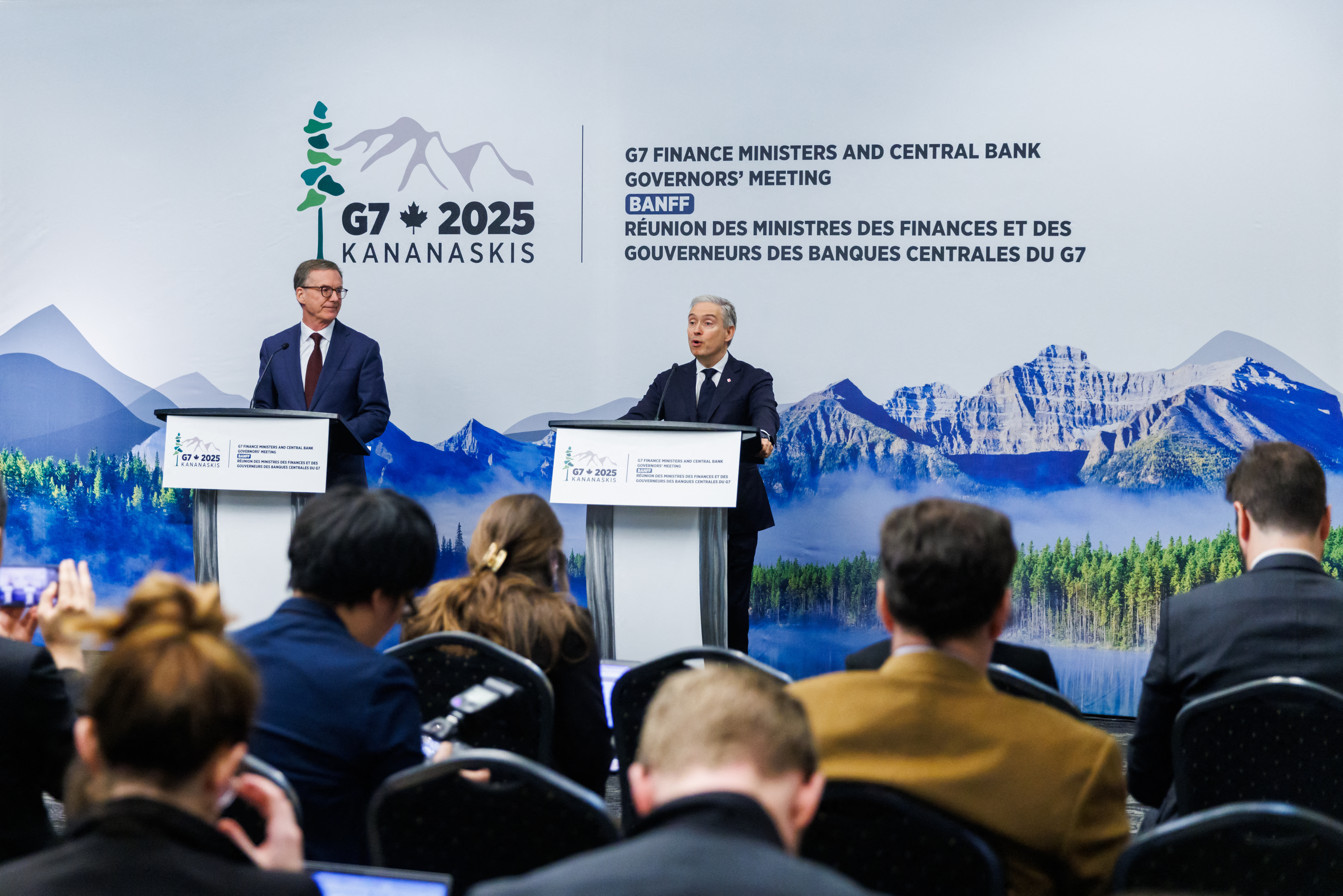 Tiff Macklem (L), Governor of the Bank of Canada looks on as Fracois-Philippe Champagne, Canada's Minister of Finance and National Revenue speaks at their closing press conference during the G7 Finance Ministers and Central Bank Governors Meeting in Banff, Alberta, Canada on May 22, 2025. Top finance leaders from the G7 nations are gathering in Canada, with concerns including war in Ukraine at the fore while the advanced economies grapple with fallout from US President Donald Trump's sweeping tariffs. (Photo by Cole Burston/ / AFP)