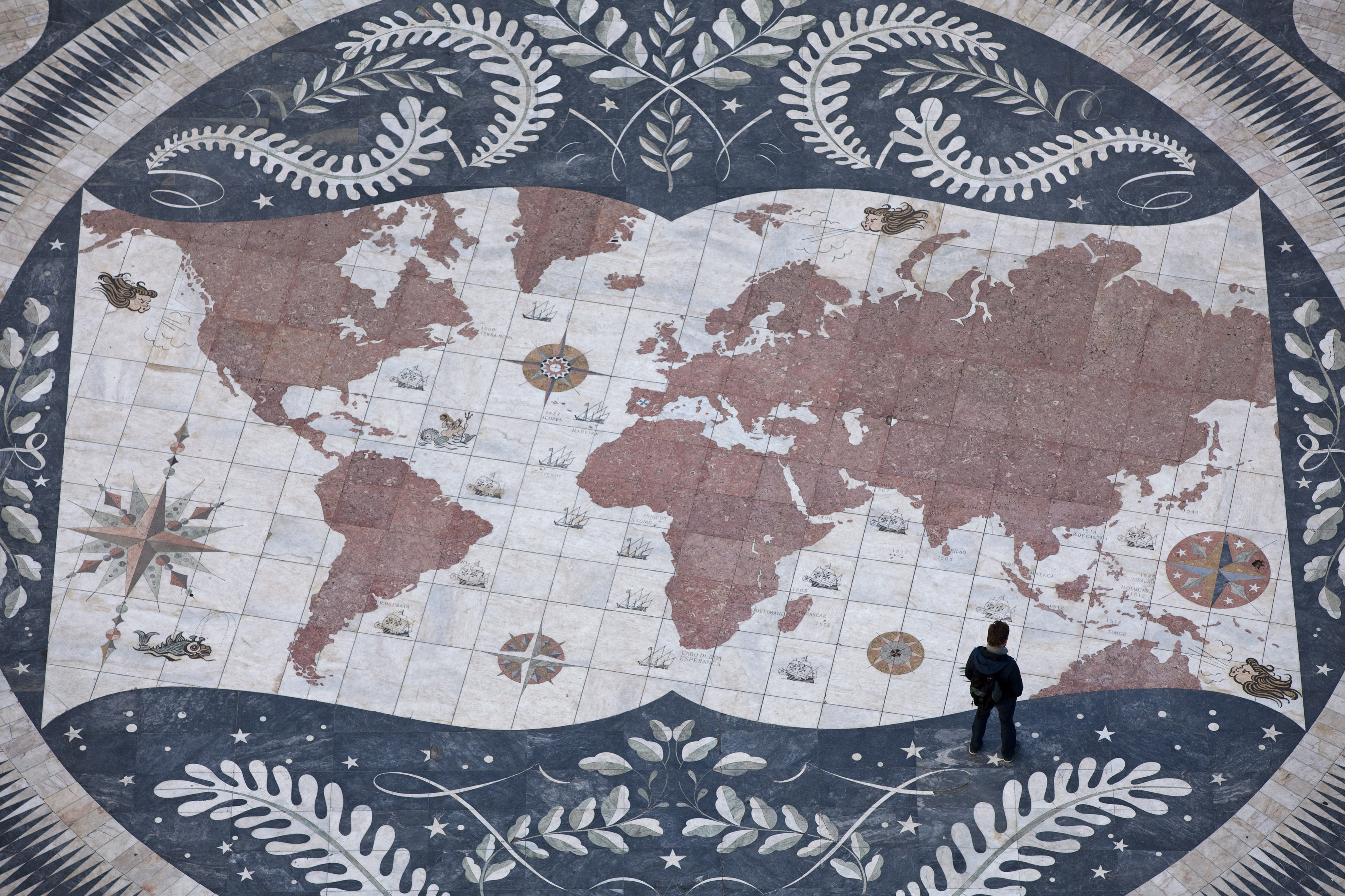 A man looks at a map of the world.